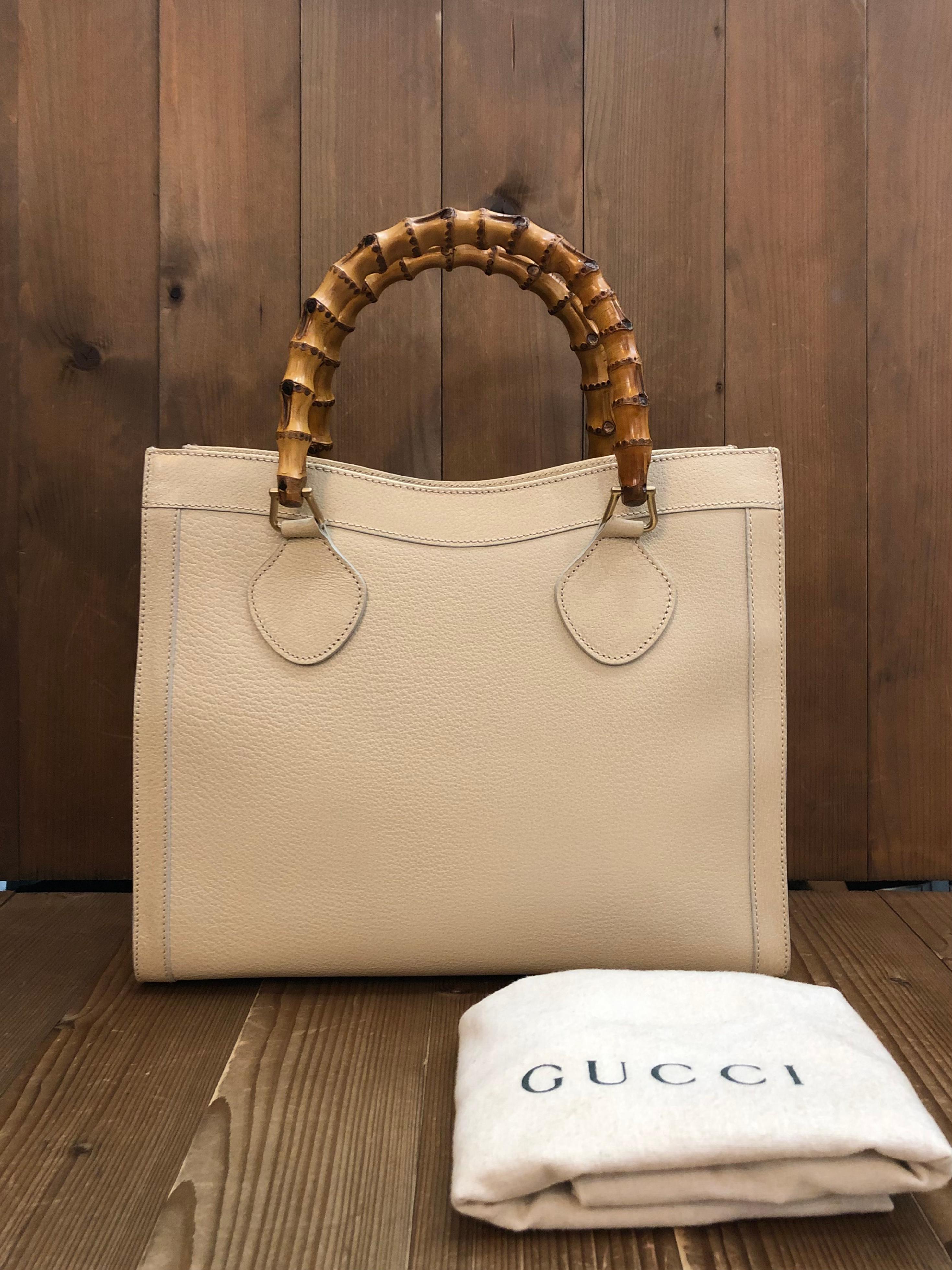 This vintage GUCCI Diana bamboo tote is crafted of pigskin’s leather in ivory and brushed gold toned hardware. Top magnetic snap closure opens to Gucci’s iconic diamanté jacquard interior featuring two main compartments/one zippered compartment with