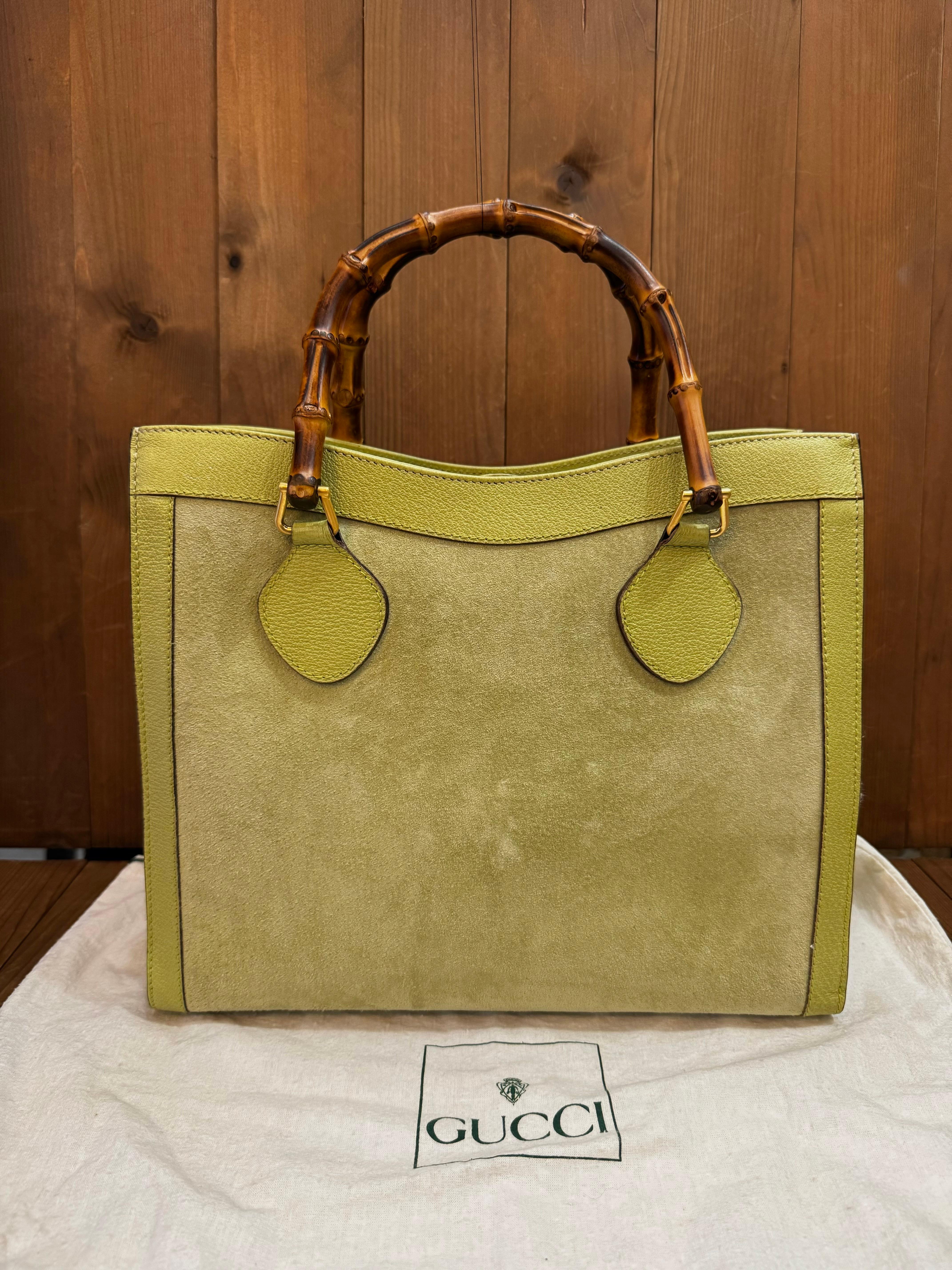 This vintage GUCCI Diana bamboo tote is crafted of pigskin leather and nubuck in green featuring matt gold toned hardware and sturdy bamboo handles. Top magnetic snap closure opens to a new interior in black featuring two main compartments with one