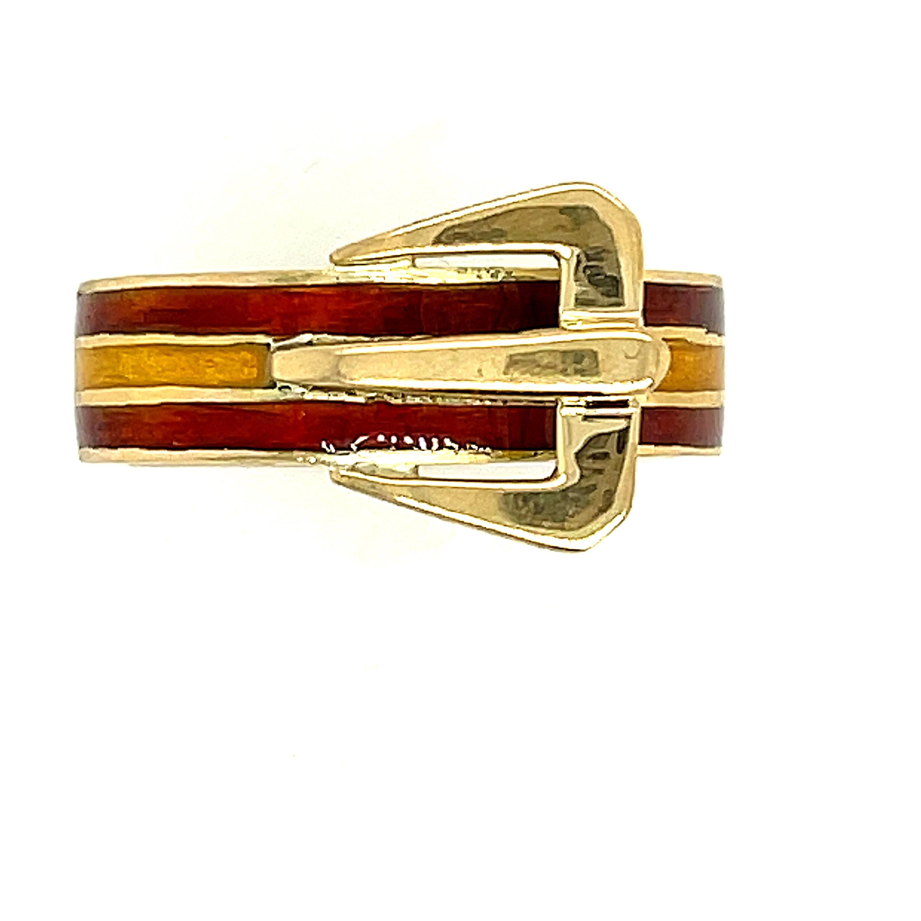A vintage enamel buckle ring with yellow and orange enamel by Gucci, circa 1970. This cute buckle ring is classic Gucci design with the bold buckle and bright colors. It matches similar bracelets and belts they made from the time. This ring is super