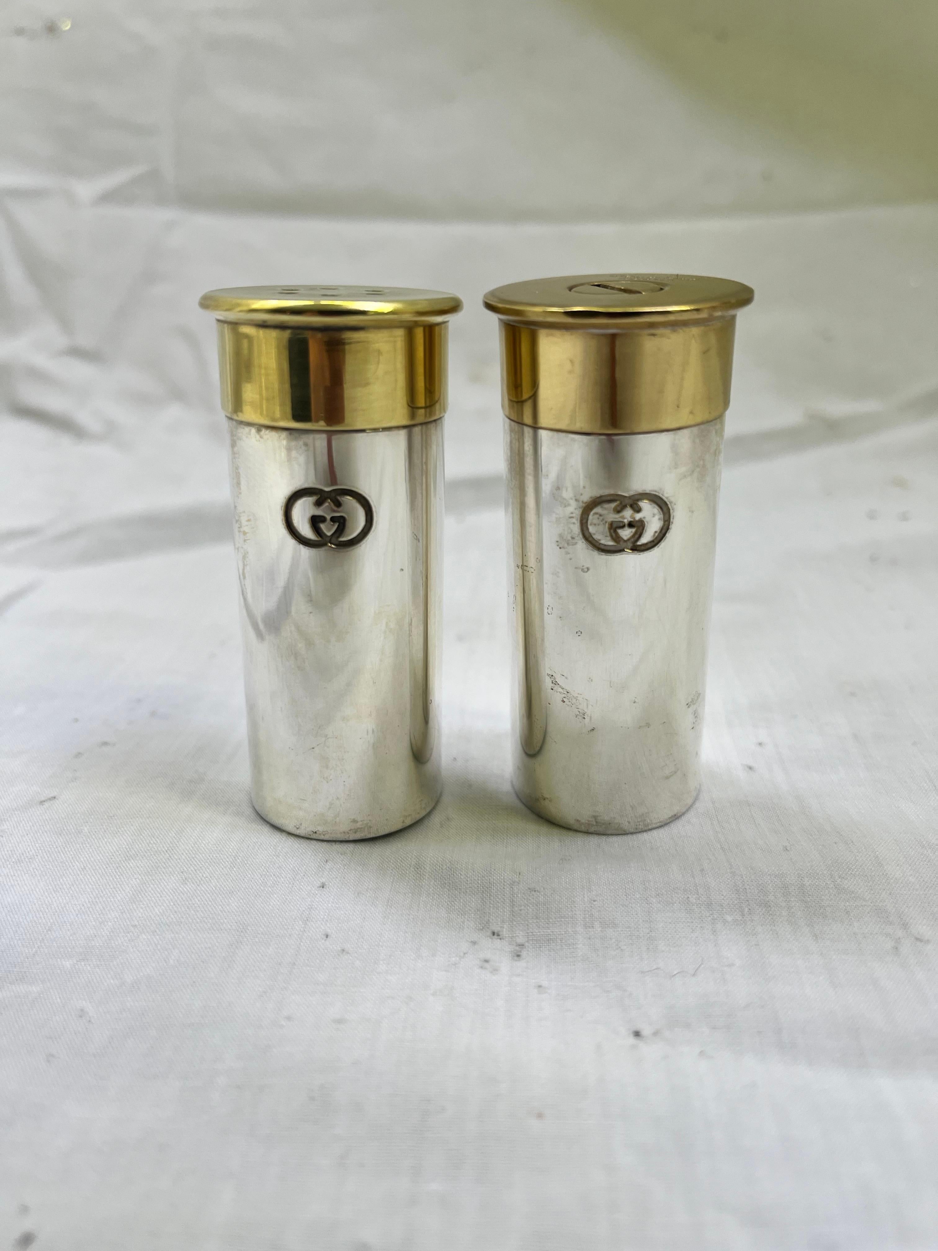 A vintage pair of circa 1980's Gucci Double G logo faux shotgun shell salt and pepper set in silver plate and brass. This set is the perfect gift for that June (shotgun wedding) bride in your life. Or perhaps it's a White Wedding, a la Billy Idol.