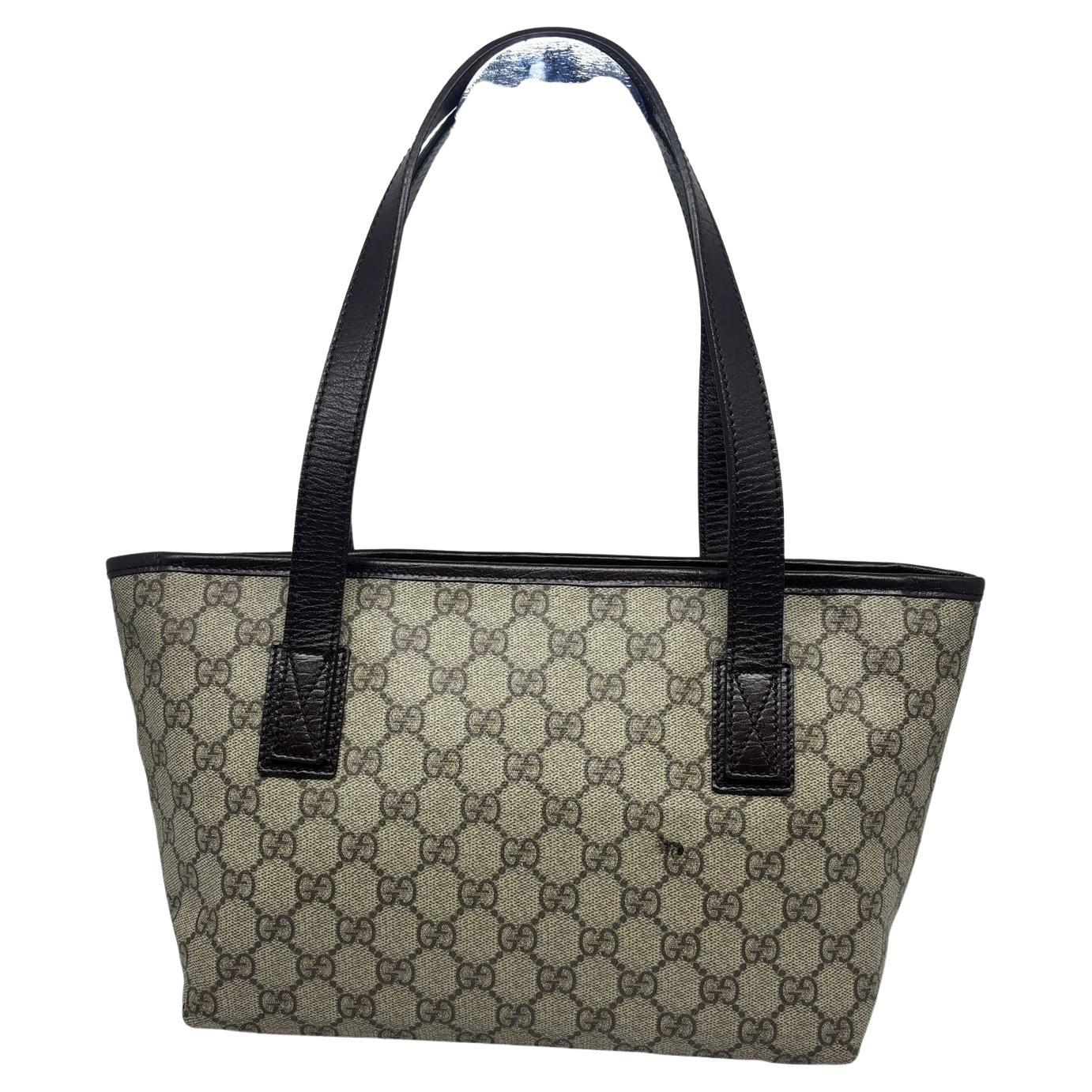 Vintage gucci tote in small size with zipper closure. Cute size for everyday use. In fair condition due to rubbing on the logo and darkening. The rubbed canvas has been fixed by spa but is not done very well (scribbling on the rubbed GG on one of