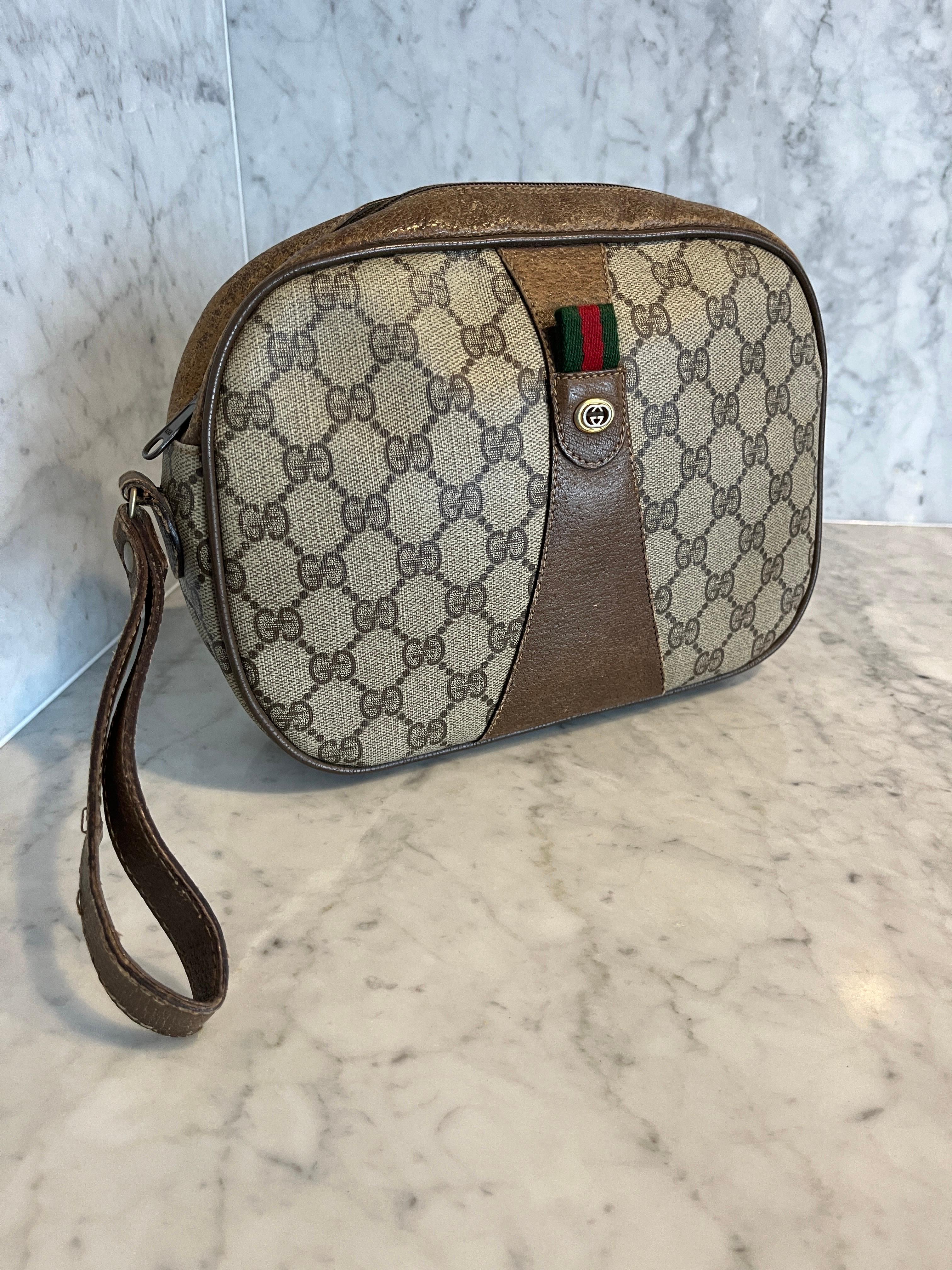 Vintage GUCCI GG PLUS pouch Bag 1970s

Gucci wrist pouch pouchet Bag
Vintage
Neutrals Coated Canvas
GG Plus
Gold-Tone Gucci Hardware
Leather Trim
Handle has some damage. 
Leather Trim Embellishment
cotton Lining has some marks and stains 
Zip