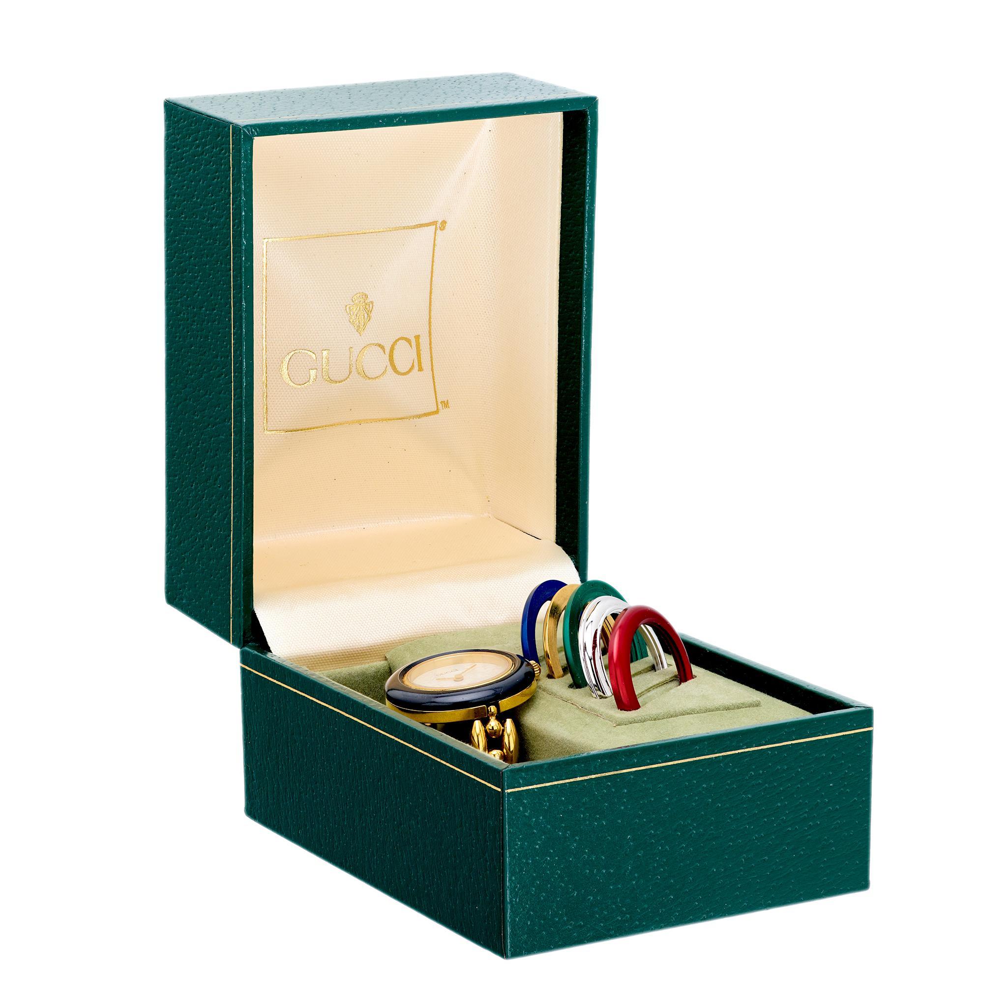 This vintage Gucci gold plated quartz watch features a signed and numbered Swiss-made design. Measuring 7 inches with an extra inch of chain, it includes the original box and weighs 27.57 grams. Crafted in the 1990s.