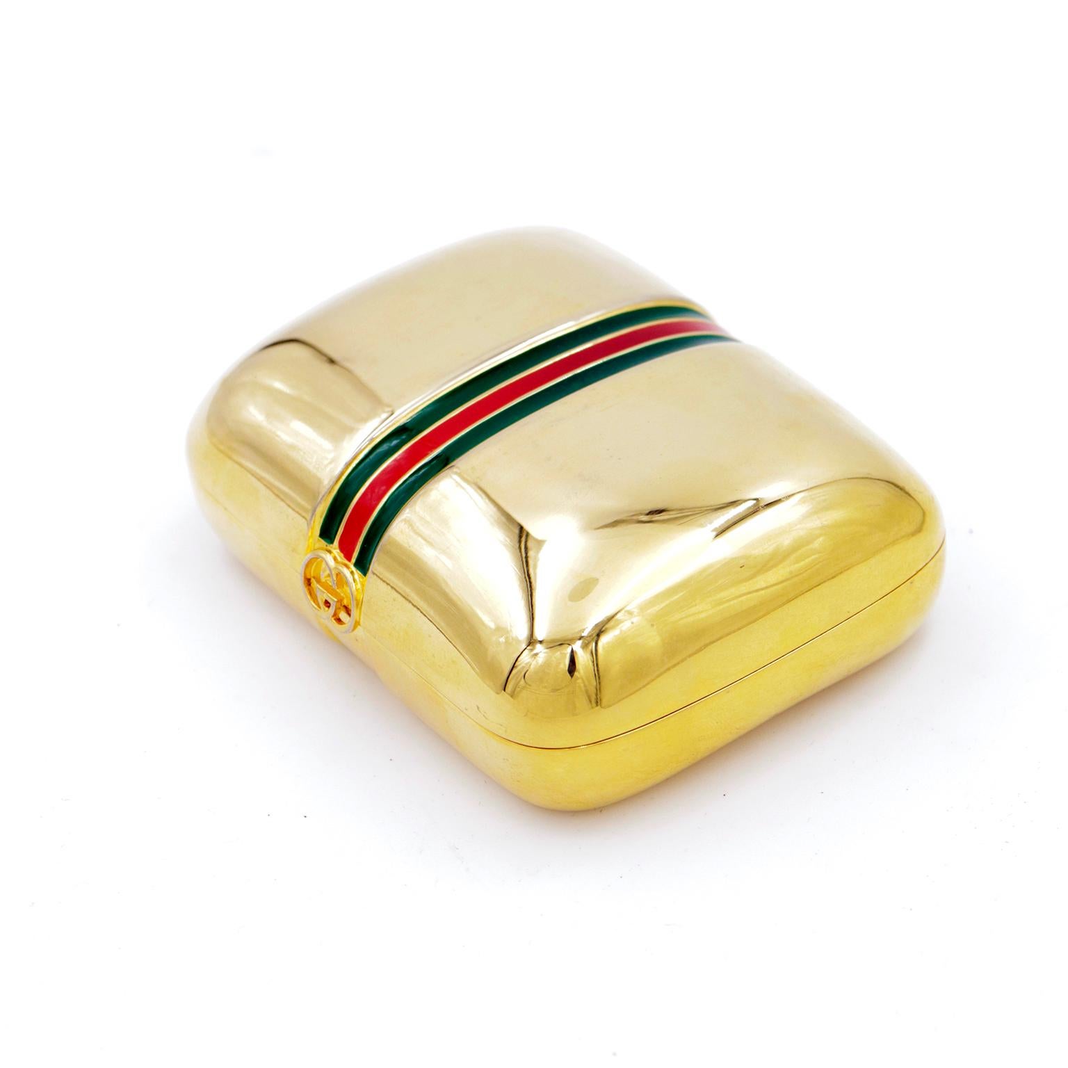 This pretty vintage 1980s gold plated Gucci trinket box has the signature Gucci red and green stripe down the center. This great case can be used to carry cards, medications,  jewelry, or even as a very small evening clutch if you don't mind leaving