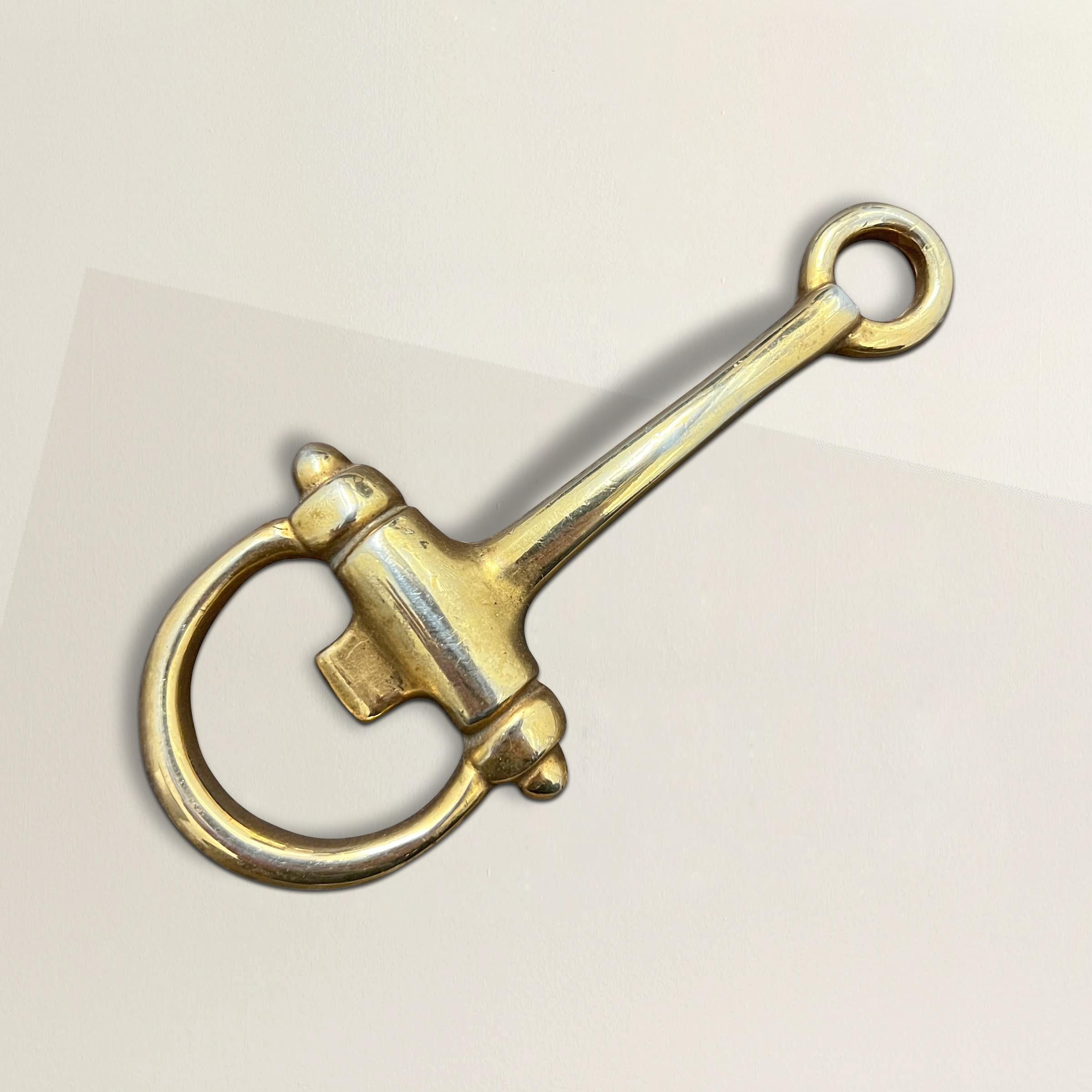 A chic Mid-20th Century Italian gold-plated horsebit bottle opener by Gucci. Purchased in Florence, Italy from a vintage fashion dealer who said this was borrowed by the Gucci Museo for an exhibition showcasing the company's housewares.
