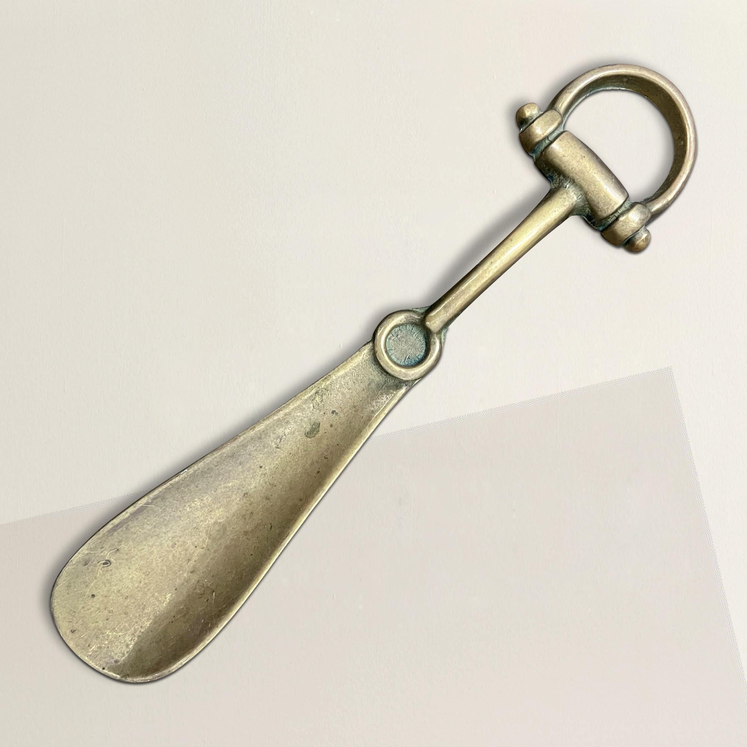 A chic Mid-20th Century Italian bronze horsebit shoehorn by Gucci. Purchased in Florence, Italy from a vintage fashion dealer who said this was borrowed by the Gucci Museo for an exhibition showcasing the company's housewares.