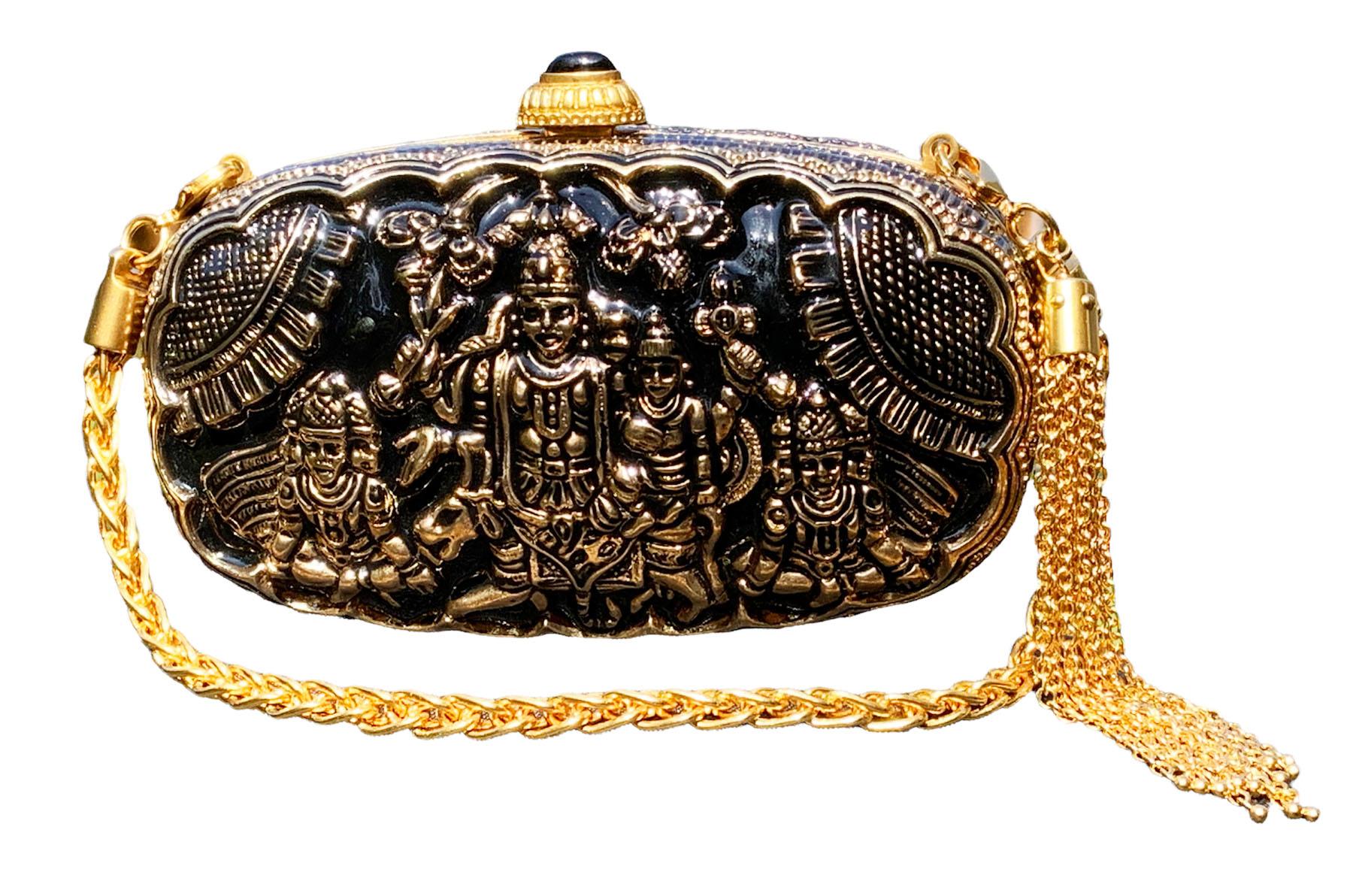 Vintage Gucci Minaudiere Embossed Gold Tone Metal and Black Enamel Clutch
Very Unique Indian Hindu Deities Embossed, Featuring a Black Enamel, and an Optional Chain-Link Strap with Tassel for Versatile Carry.
Black Satin Interior and Push-Lock