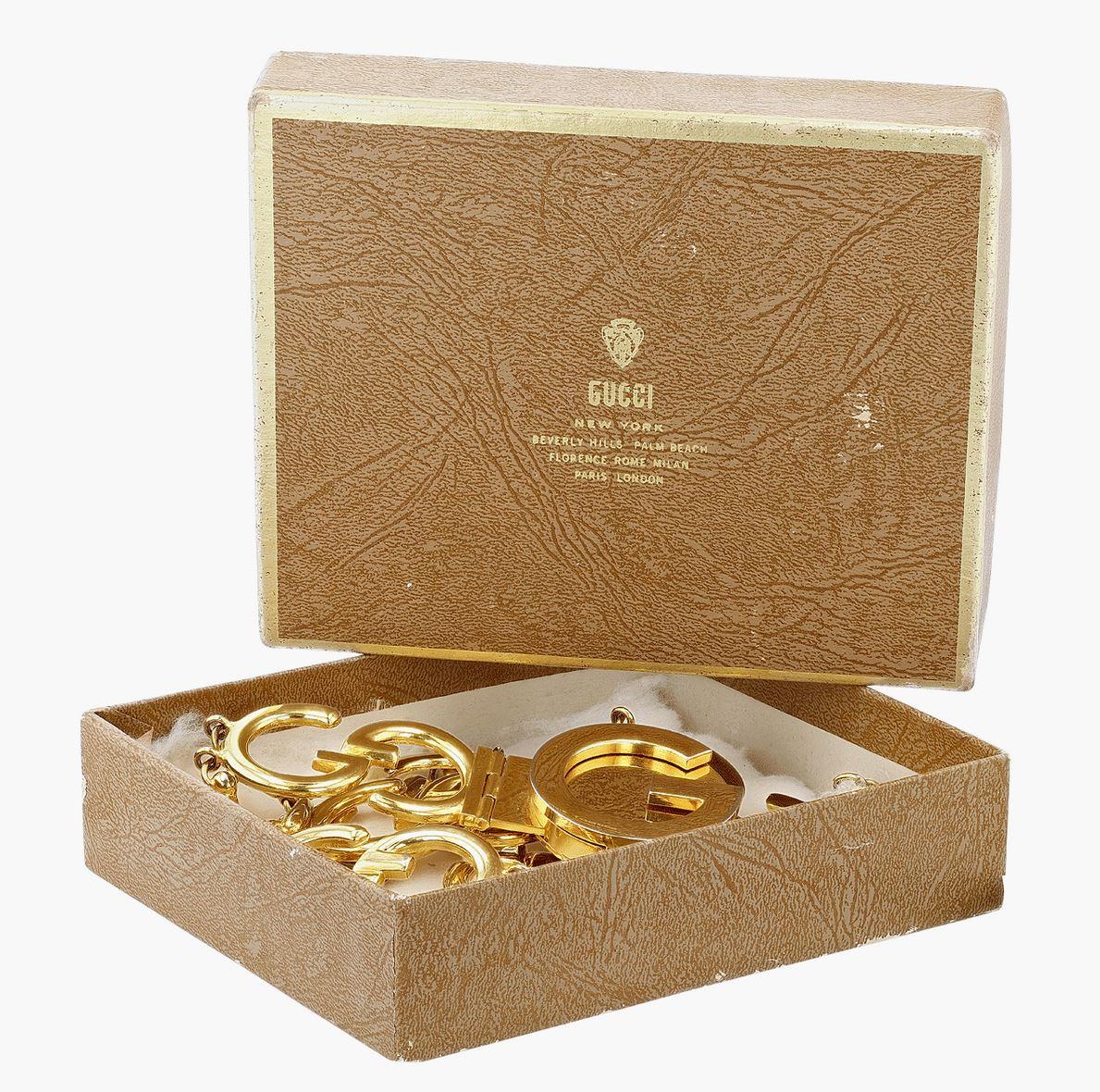 A circa 1970s Gucci belt featuring the iconic interlocking-Gs that are the signature of the famed Italian fashion house. Accompanied by it's original box, this gold-plated Gucci belt is in exceptional condition for its age. 

Composed of 7