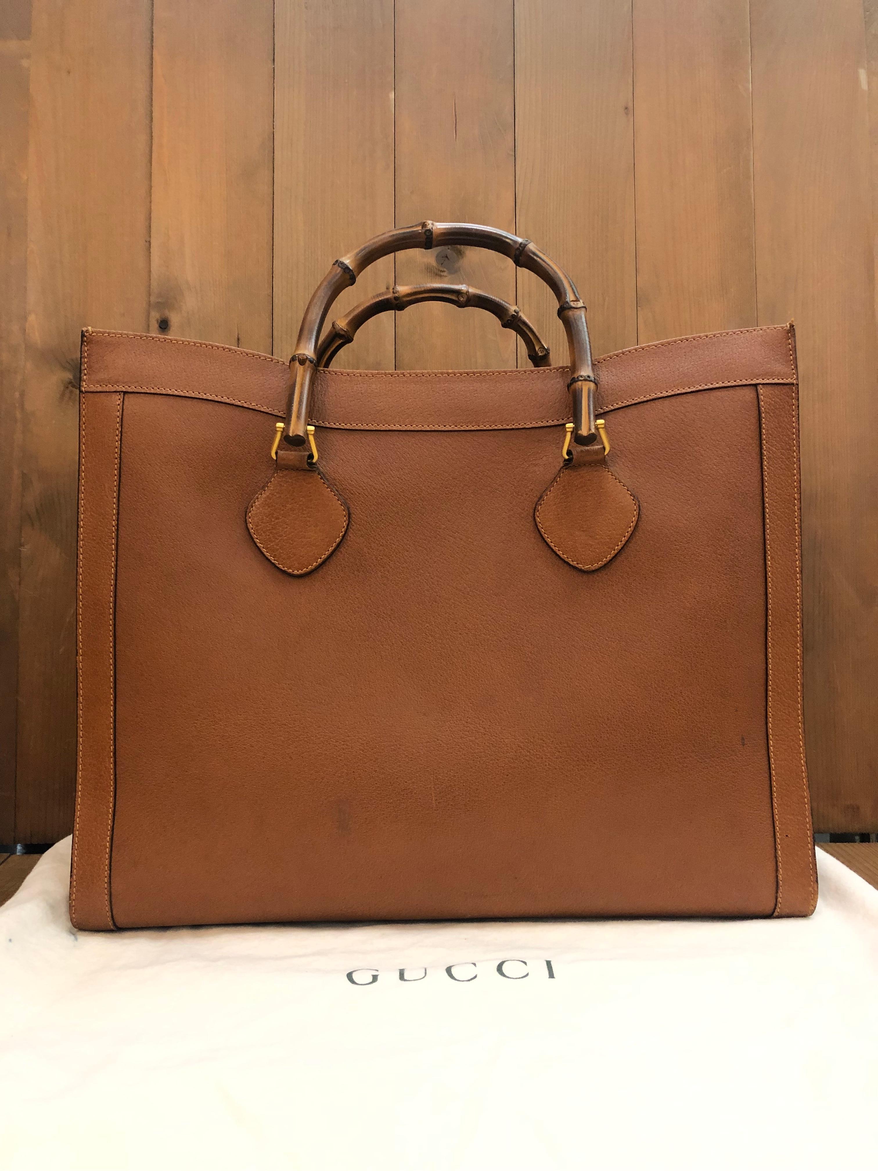This large vintage Gucci Diana bamboo tote bag is crafted of pigskin leather in caramel brown featuring matte gold-toned hardware and bamboo handles. Wide top opens to one single compartment lined with brown leather featuring a zippered pocket. This