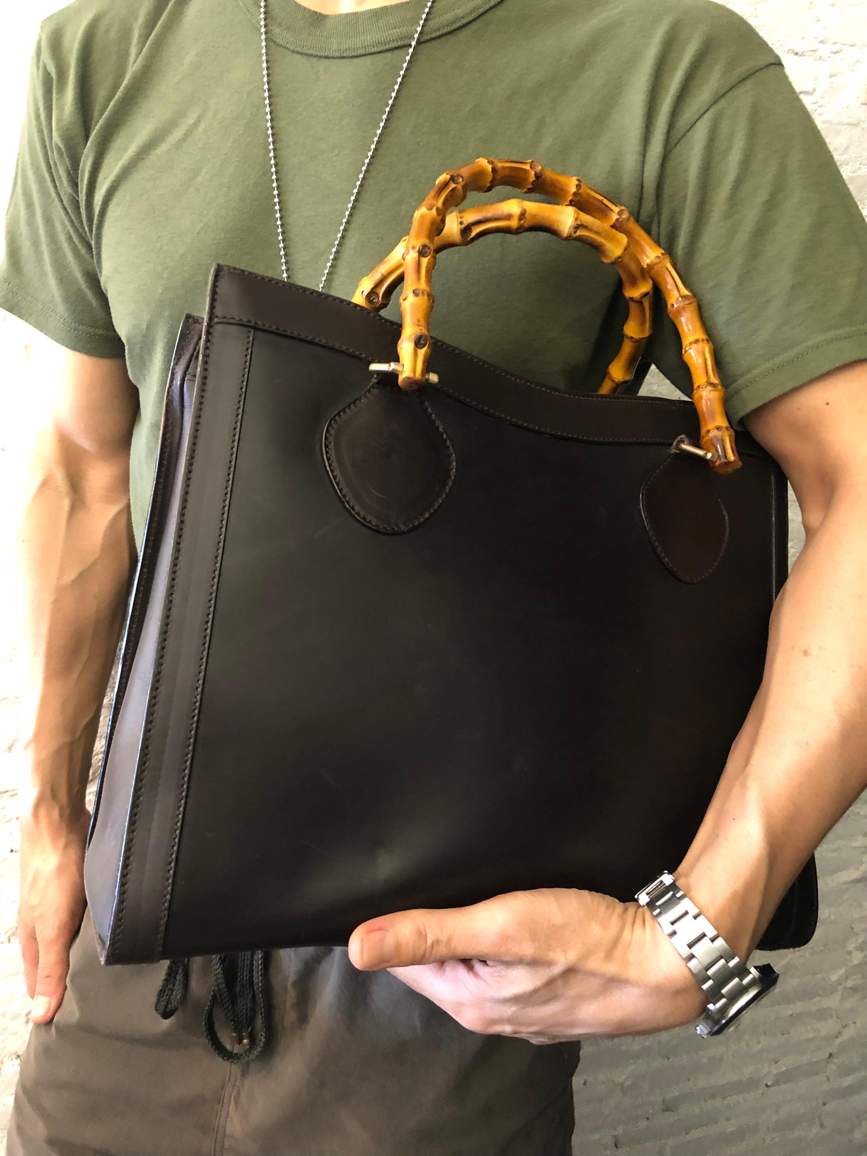 This vintage GUCCI Diana bamboo tote is crafted of smooth leather in dark chocolate brown and brushed gold toned hardware. Top magnetic snap closure opens to a new interior in beige featuring two main compartments/one zip compartment with one
