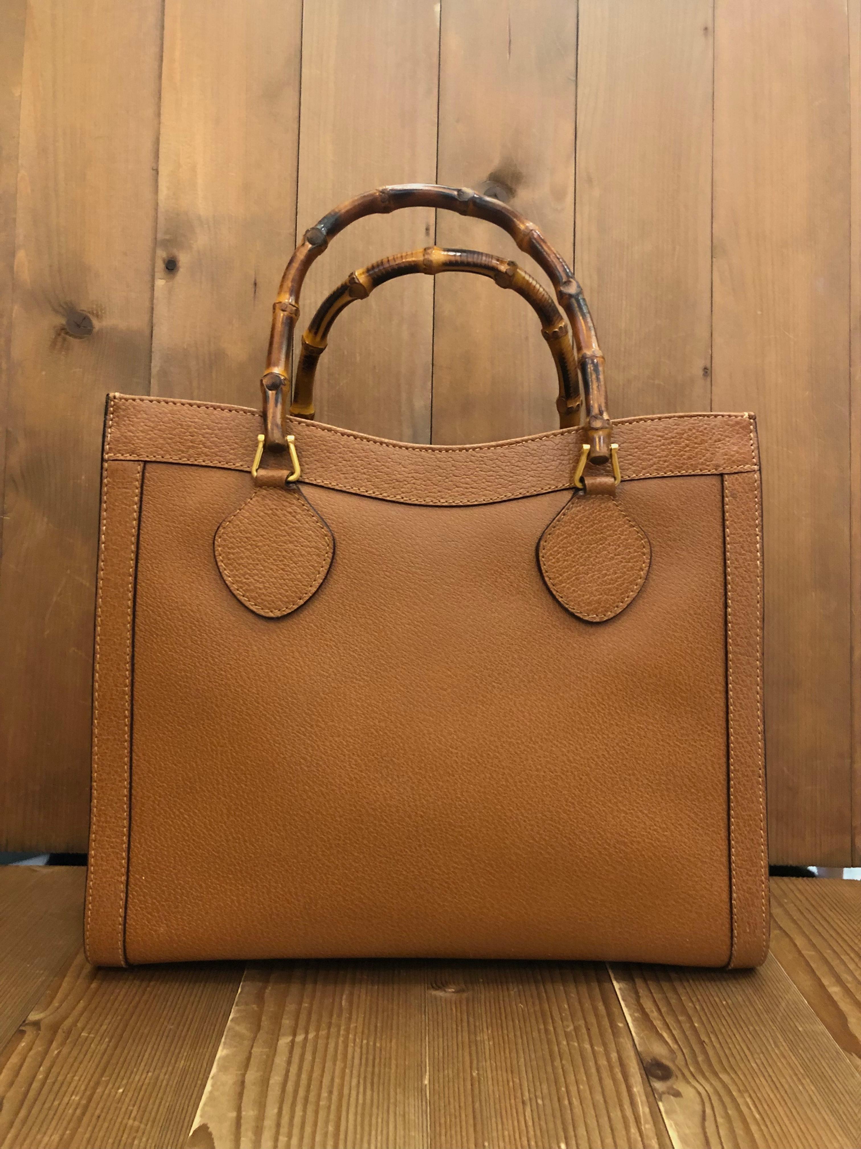 This vintage GUCCI Diana bamboo tote is crafted of pigskin’s leather in caramel brown and brushed gold toned hardware. Top magnetic snap closure opens to a new fabric interior featuring two main compartments/one zip compartment with one interior