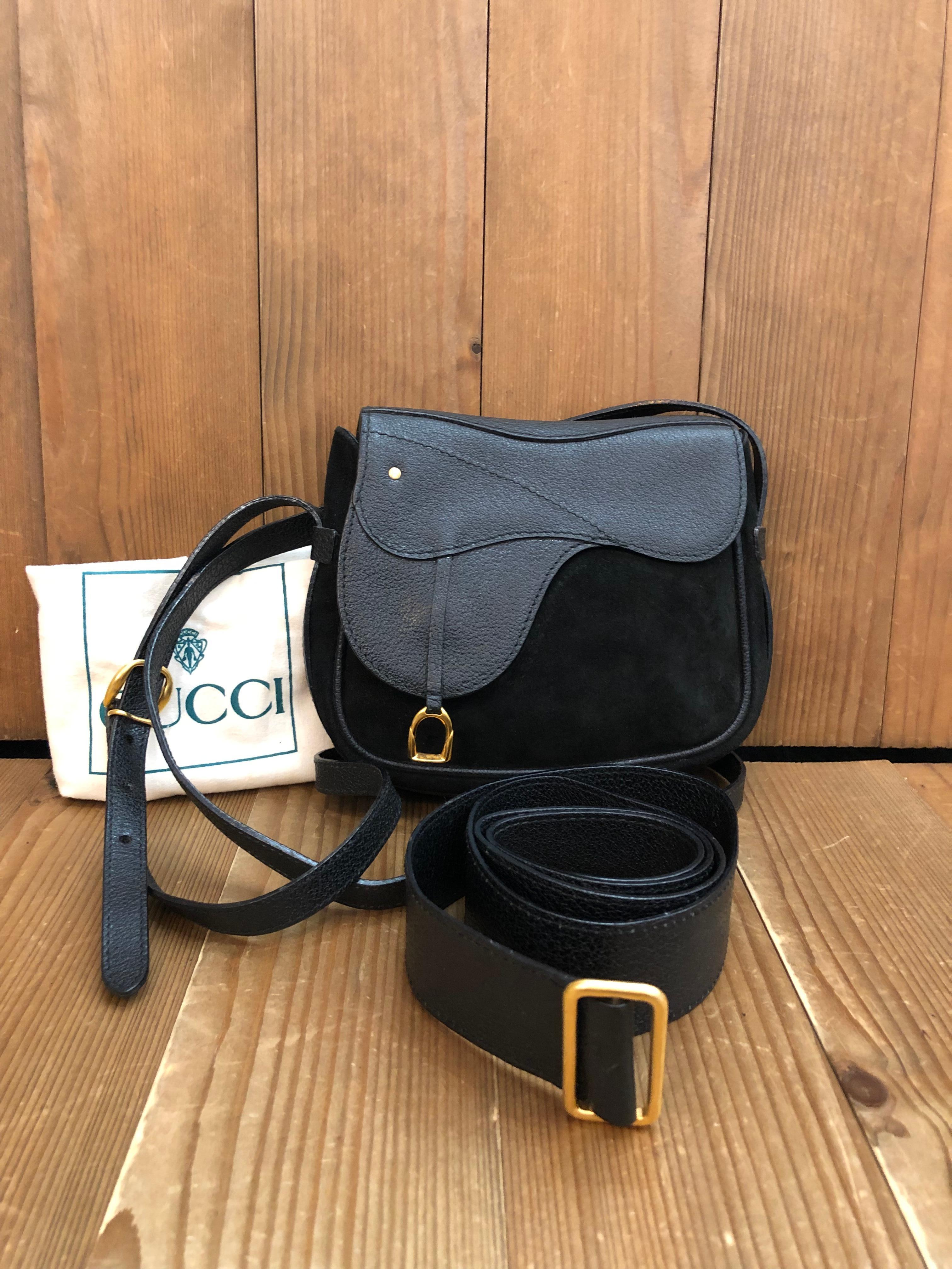 This vintage GUCCI mini saddle bag is crafted of pigskin and nubuck leather in black featuring gold toned hardware. This bag features a detachable crossbody strap and a belt of the same leather for wearing it as a crossbody or belt bag. Front