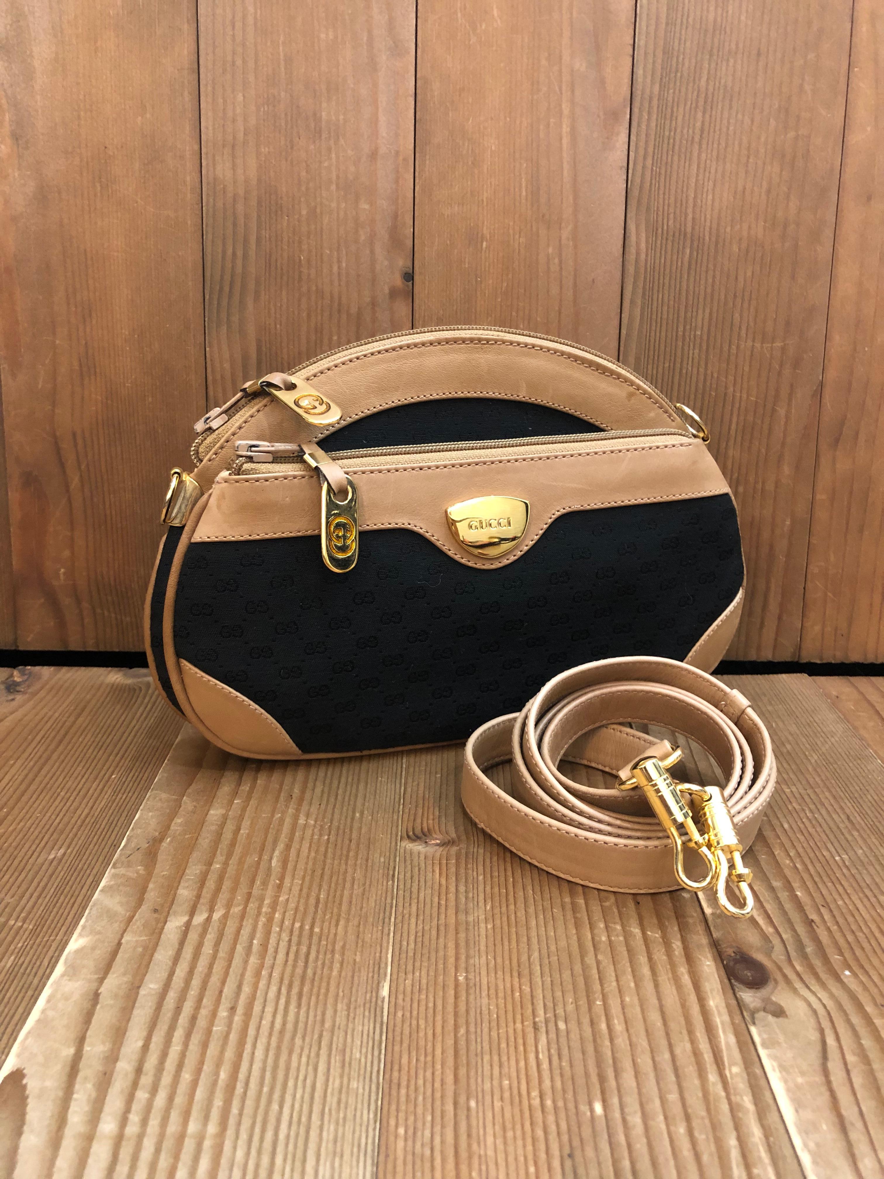 This Vintage GUCCI crossbody bag is crafted of micro GG jacquard in black trimmed with smooth calfskin leather in beige and gold toned hardware. This Gucci features two flat zippered pockets lined with beige pigskin leather with one interior
