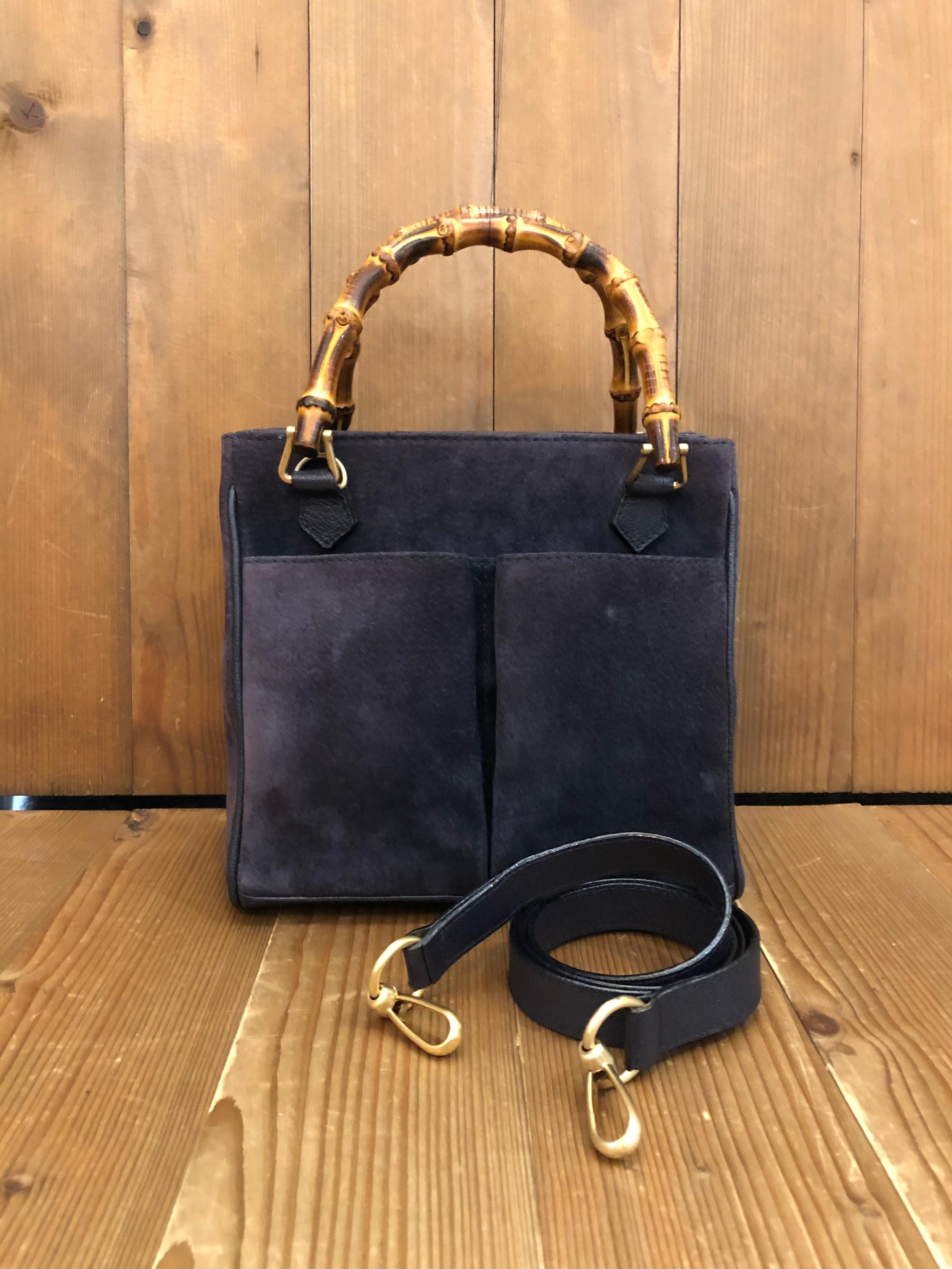 This 1990s vintage GUCCI small 2-way shoulder bag is crafted of suede and pigskins leather in navy and matt gold toned hardware. The front of this bag features two open pockets. Top magnetic snap closure opens to a diamanté jacquard interior in navy