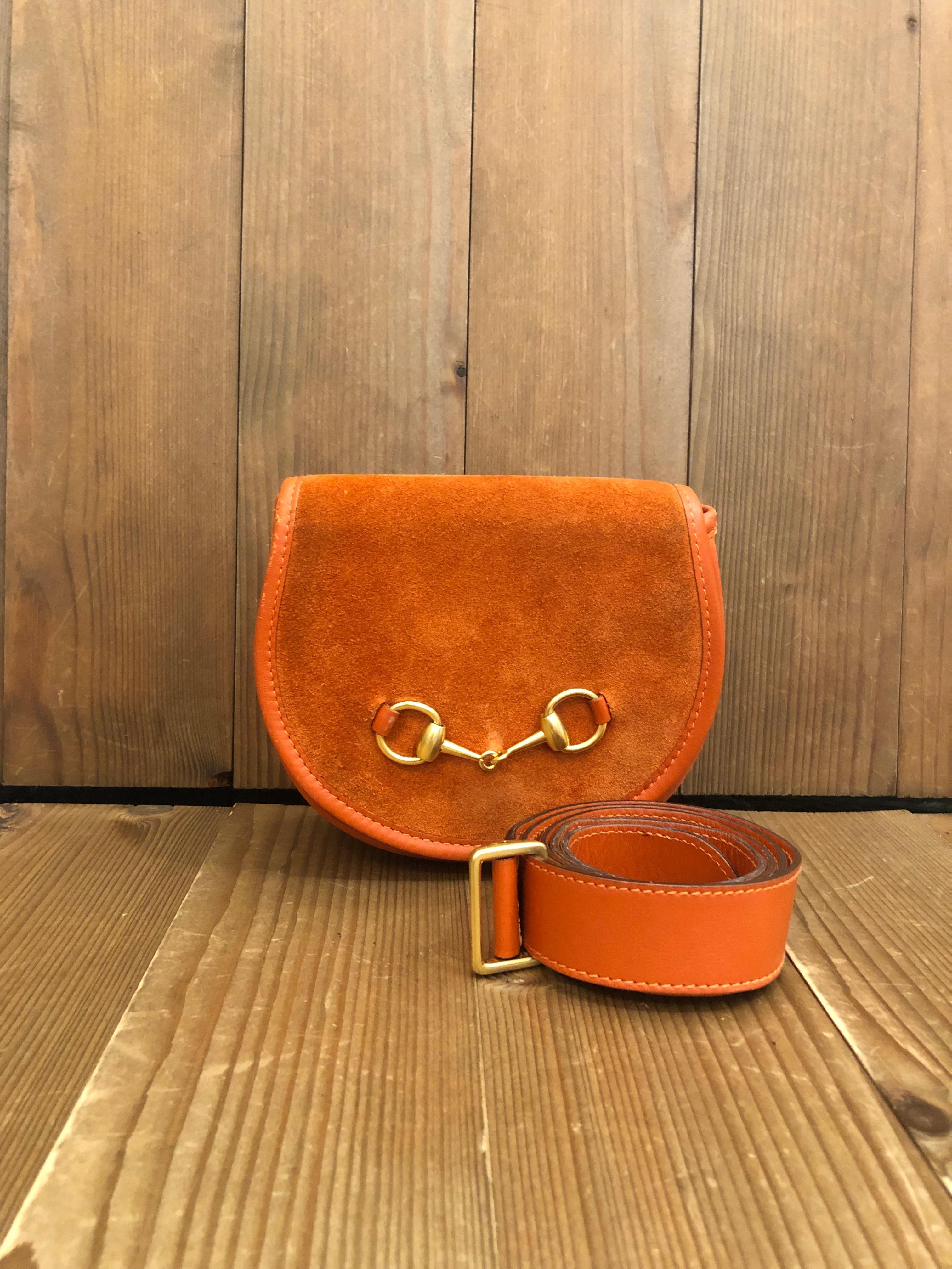 This vintage GUCCI belt bag is crafted of suede and calf leather in orange featuring a gold toned horsebit. This Gucci belt bag comes with a detachable belt of the same leather. Front flap magnetic snap closure opens to a beige coated interior which