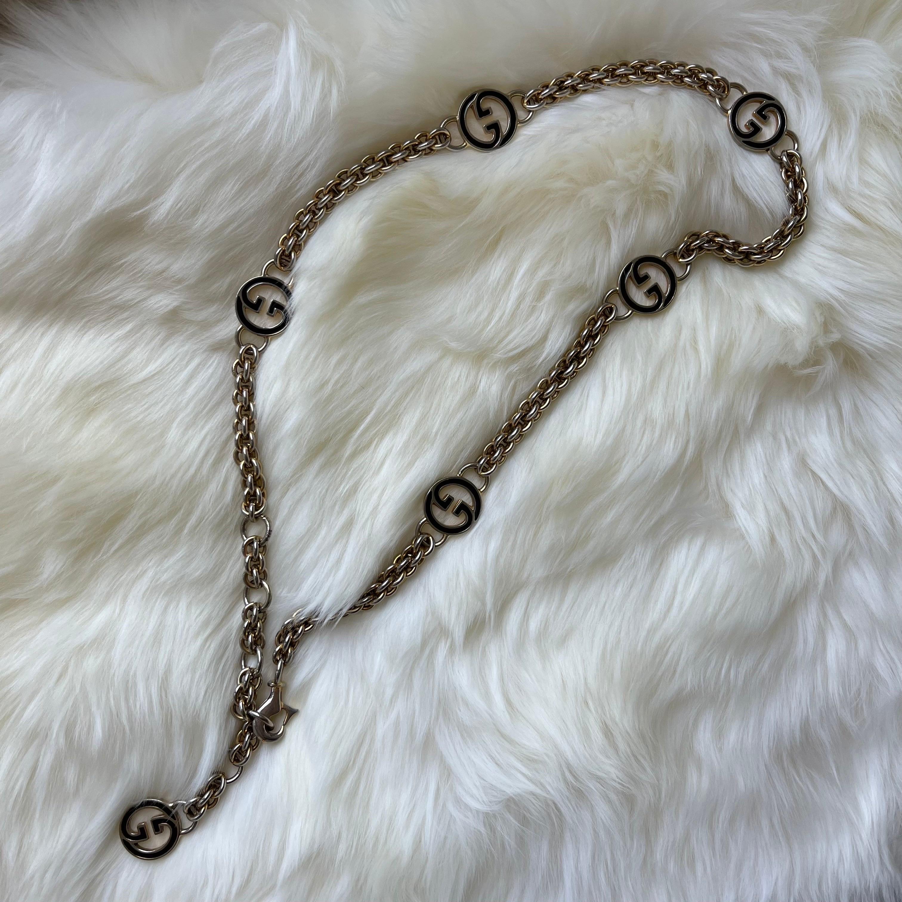 This stunning vintage Gucci necklace features a two tone, gold and silver chain, and black GG pendents. 

In such amazing condition, you can wear it a million ways! You Cain make it a chunky bracelet, falling down necklace, or even a waist