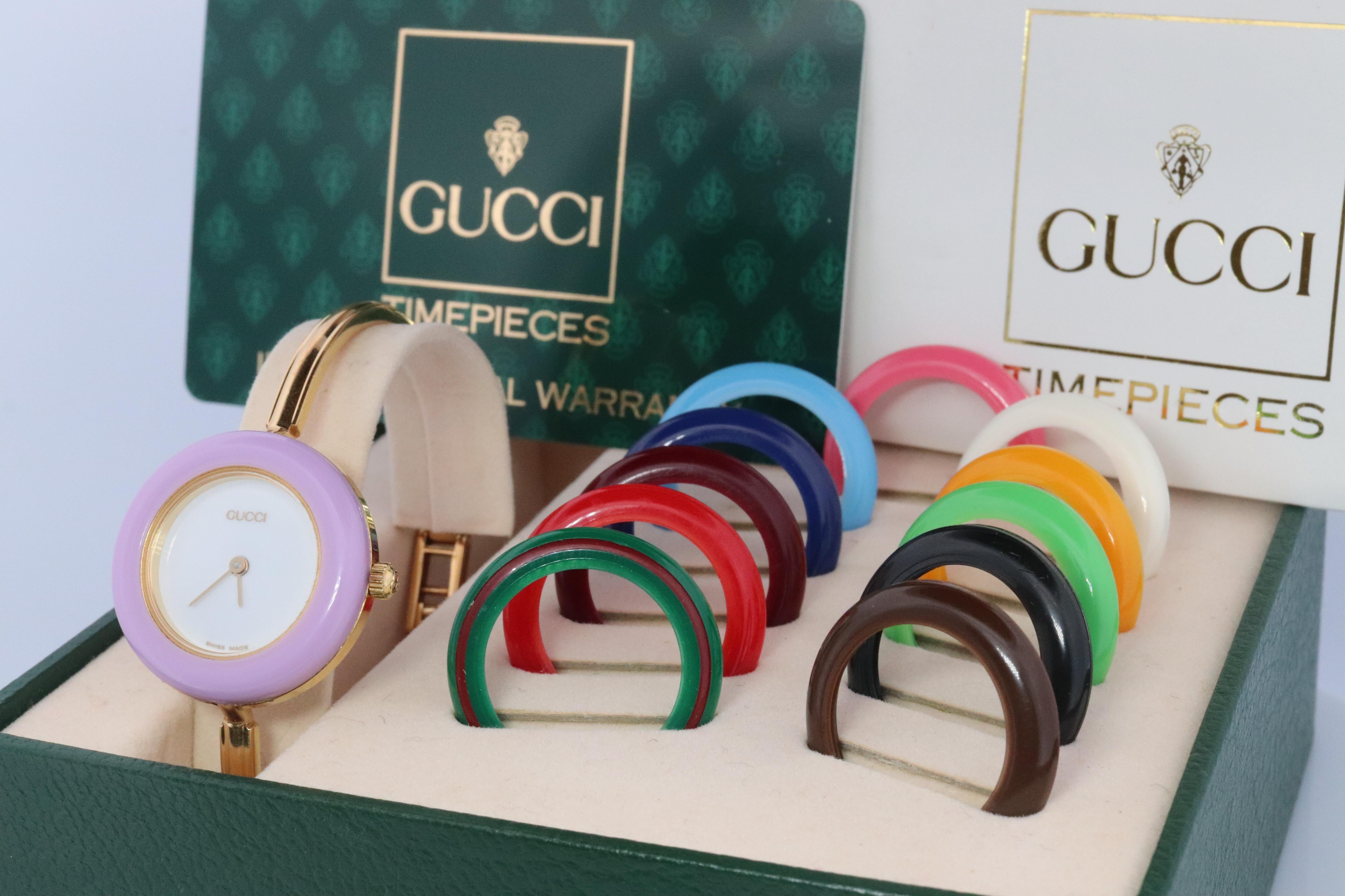 Genuine Gucci Watch.

11/12.2 Reference number.

Gold Tone with interchangeable bezels.

Original Box, Original paperwork, and Gucci Card Included

Condition: New battery. Comes with original box and original bezels. Please review photos for