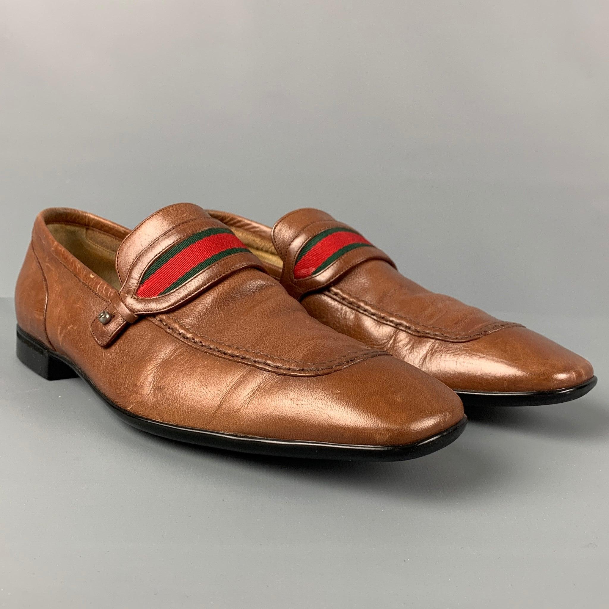 Vintage GUCCI loafers comes in tan leather featuring signature stripe trim, detachable strap, slip on, and a square toe. Made in Italy.
Good
Pre-Owned Condition. 

Marked:   7.5 D Outsole: 11.75 inches  x 4 inches 
  
  
 
Reference:
