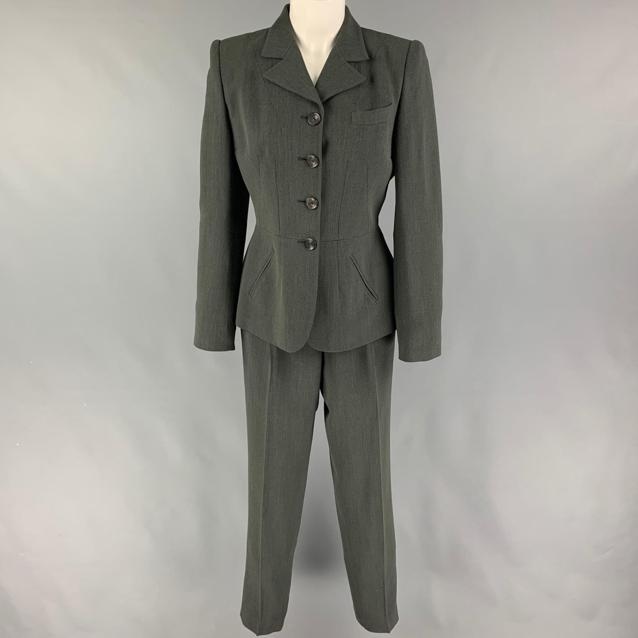 Vintage GUCCI
suit comes in a grey wool 
/ rayon with a full liner and includes a single breasted, four button sport coat with a notch lapel and matching pleated
 front trousers. Made in Italy. Very Good Pre-Owned Condition. 

Marked:   42