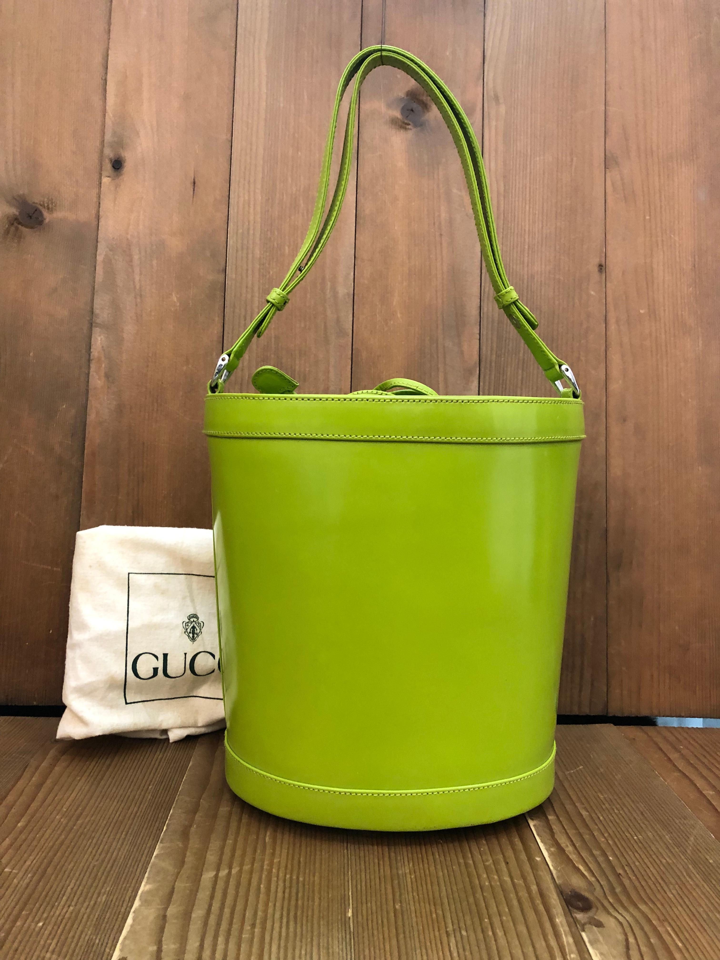 This vintage GUCCI 2-way bucket bag is crafted of smooth leather and nubuck leather in lime green. Top drawstring closure in nubuck leather opens to a coated interior which has been professionally cleaned featuring a zippered pocket. This Gucci