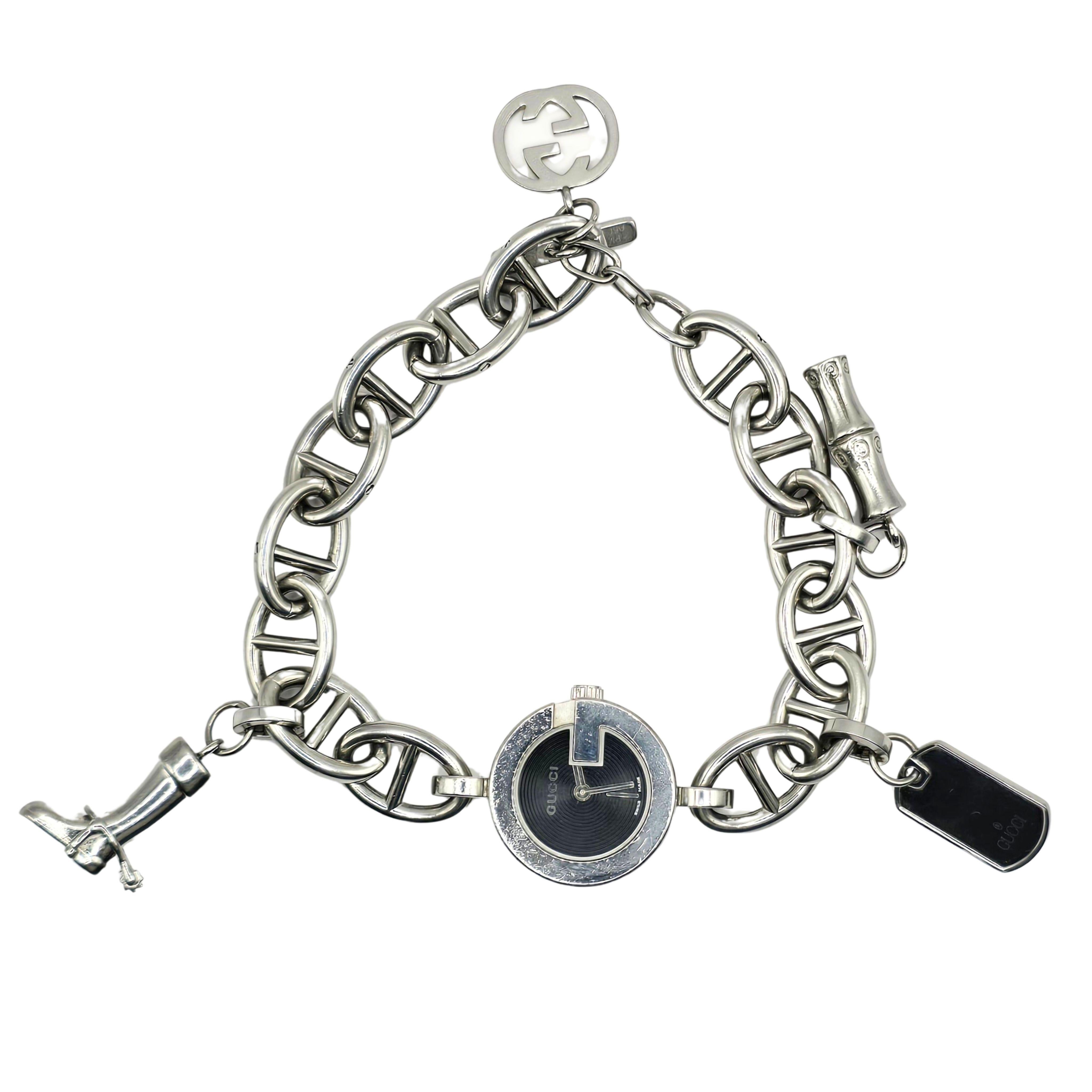 A beautiful, chunky stainless steel bracelet watch from Gucci featuring 4 removable charms.  

The Details:
Model: YA107503
Serial Number: 10484975
Case Size: 22mm 
Dial Color: Black
Glass: Scratch and reflection resistant Sapphire Crystal
Movement: