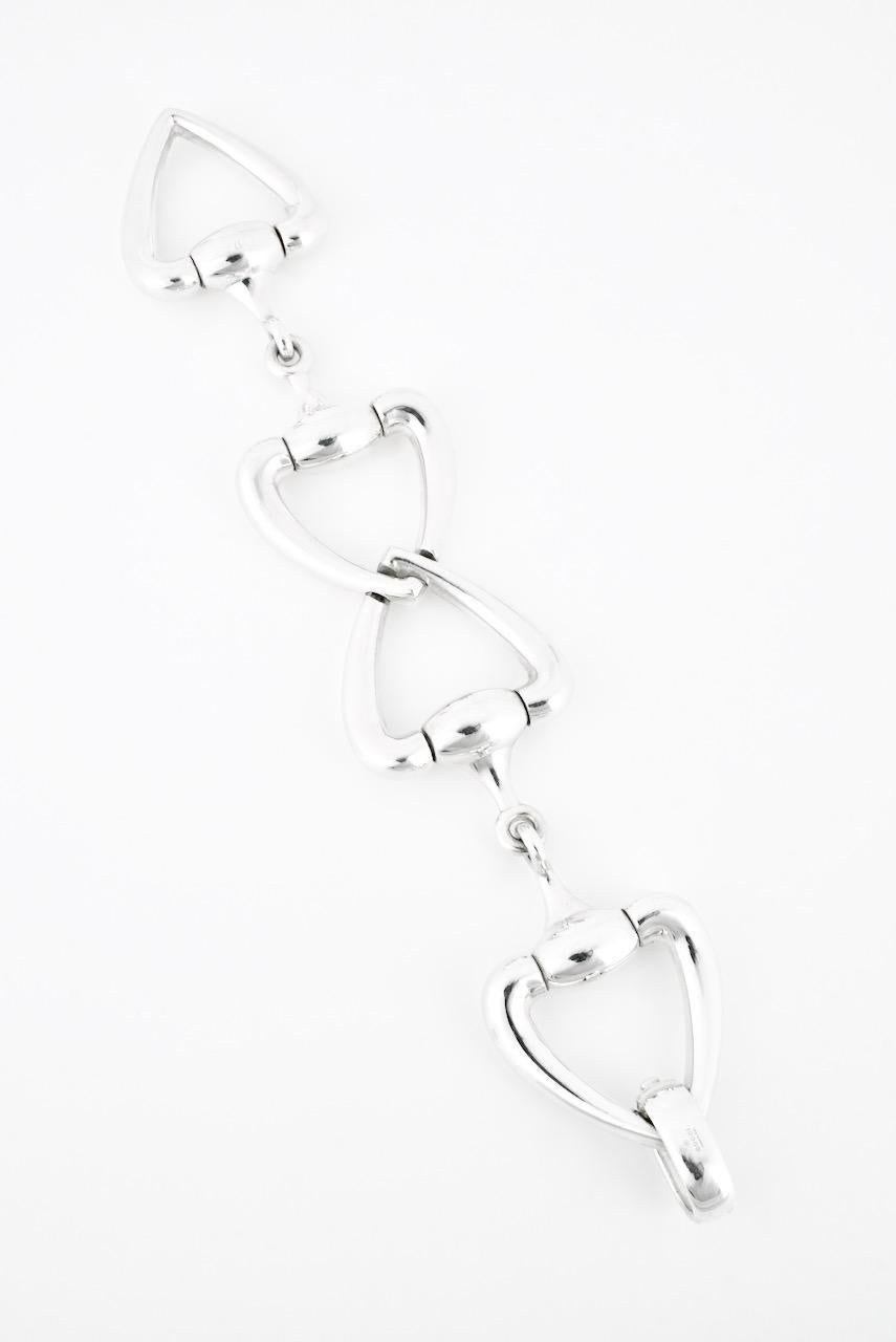 A vintage solid silver heart horse bit bracelet comprised of four heart shape motifs on either side of a horse bit link with a hinged closure - although a more recent piece, this heavy beautiful bracelet was produced in small numbers and so is a