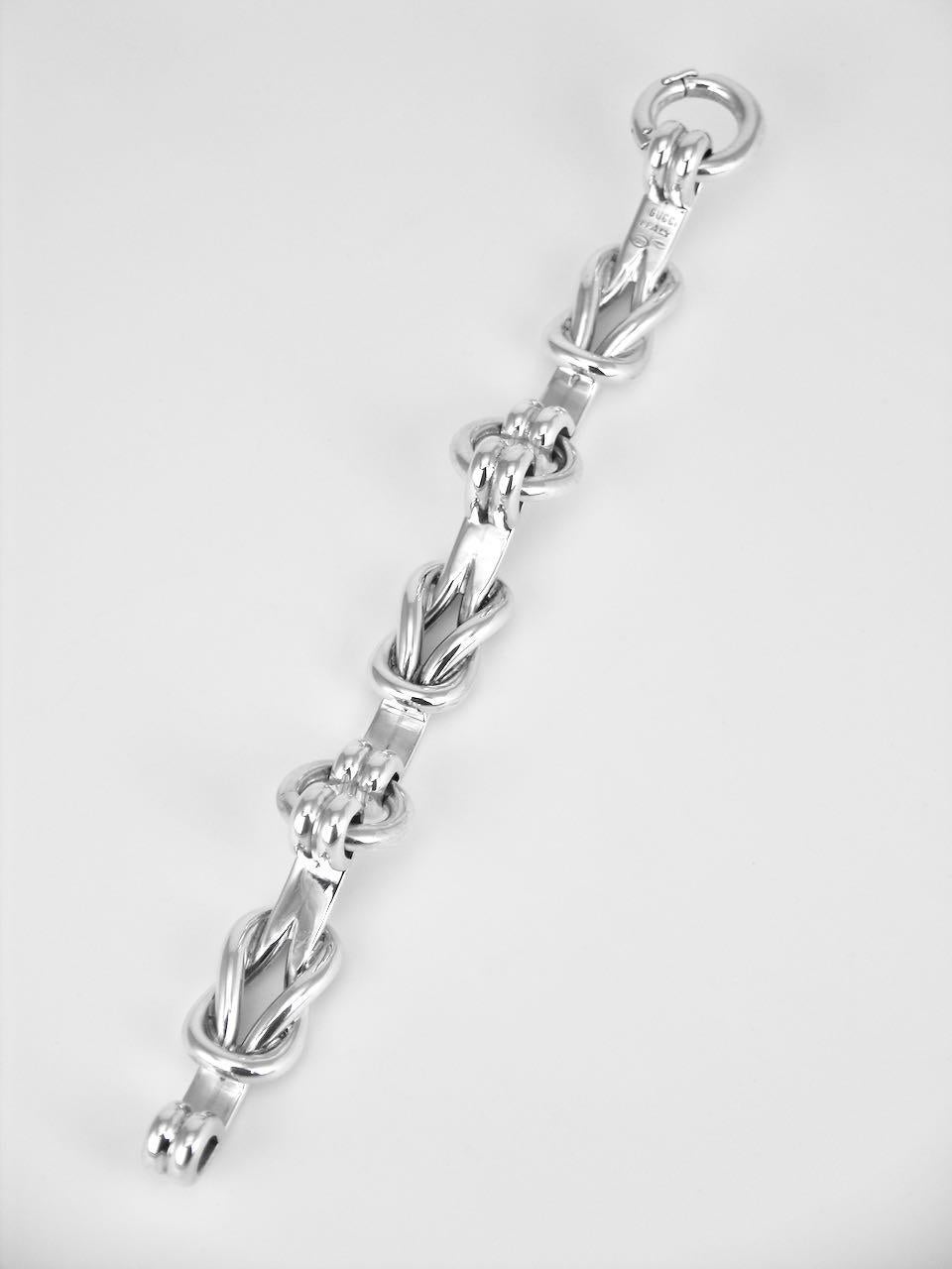 This designer solid silver heavy bracelet is made up of three panels of a Hercules knot and linked with large round links with an integrated split link clasp with safety clasp.  This iconic design with a nautical flavour is very rare to find and