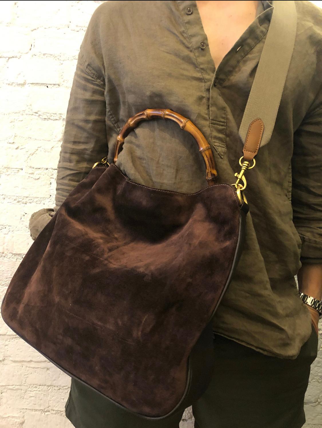 This vintage GUCCI 2-way shoulder bag is crafted of suede and smooth leather in brown and matt gold toned hardware. Top magnetic snap closure opens to new brown fabric interior with a zippered pocket. Made in Italy. Measures approximately 15 x 13 x