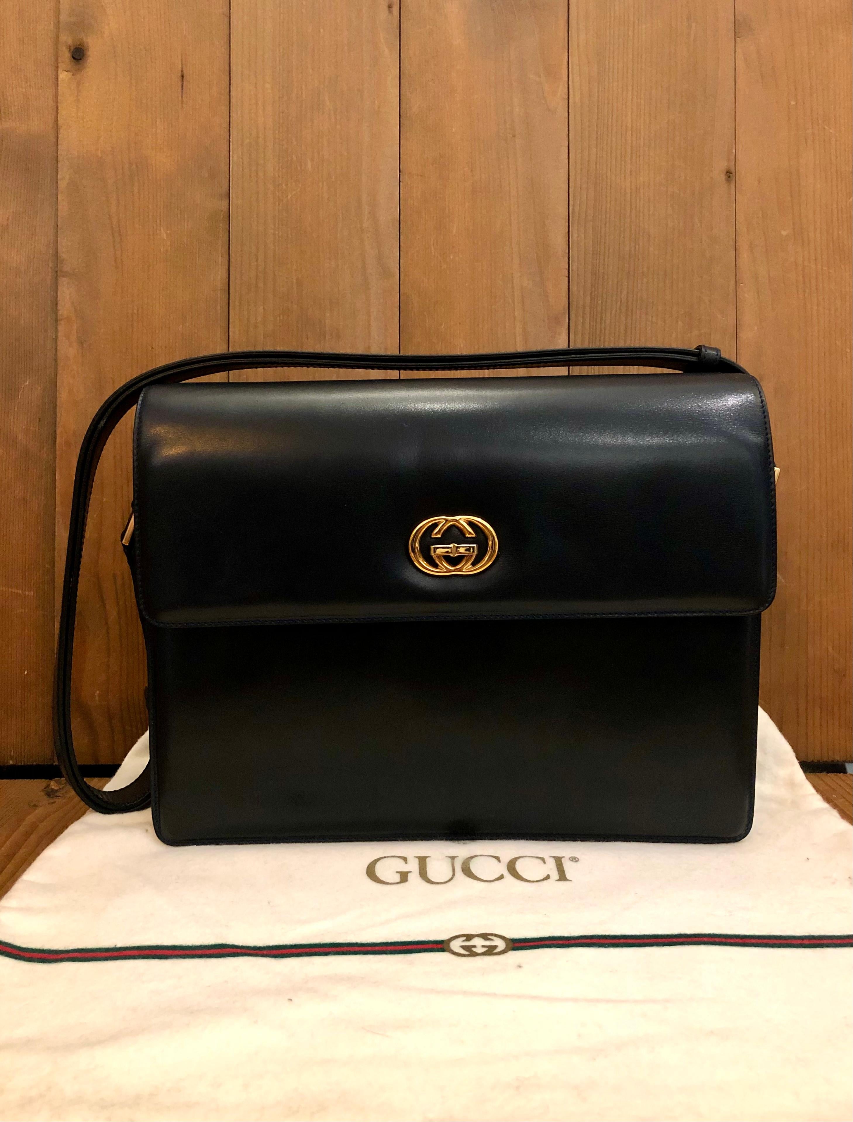 This vintage GUCCI shoulder crossbody bag is crafted of smooth calfskin leather in dark navy featuring gold toned hardware. Front flap GG turnlock closure opens to a navy leather interior featuring a zippered pocket. Adjustable leather strap allows