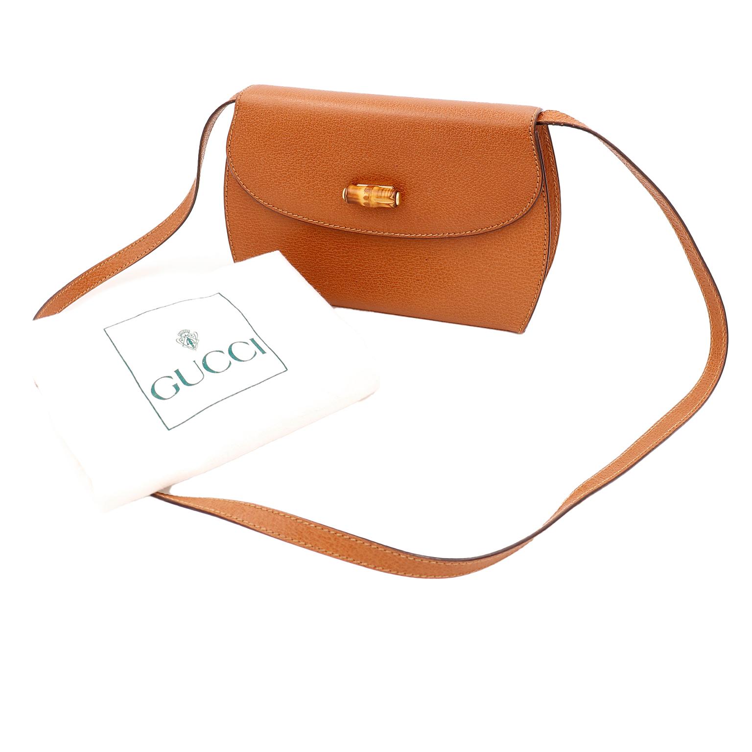 This vintage 1980's Gucci bag was never used and comes with its original dust bag. This pretty light toffee brown pebble Leather handbag can be carried as a clutch if you remove the shoulder strap, or worn crossbody. We love the unique bamboo accent