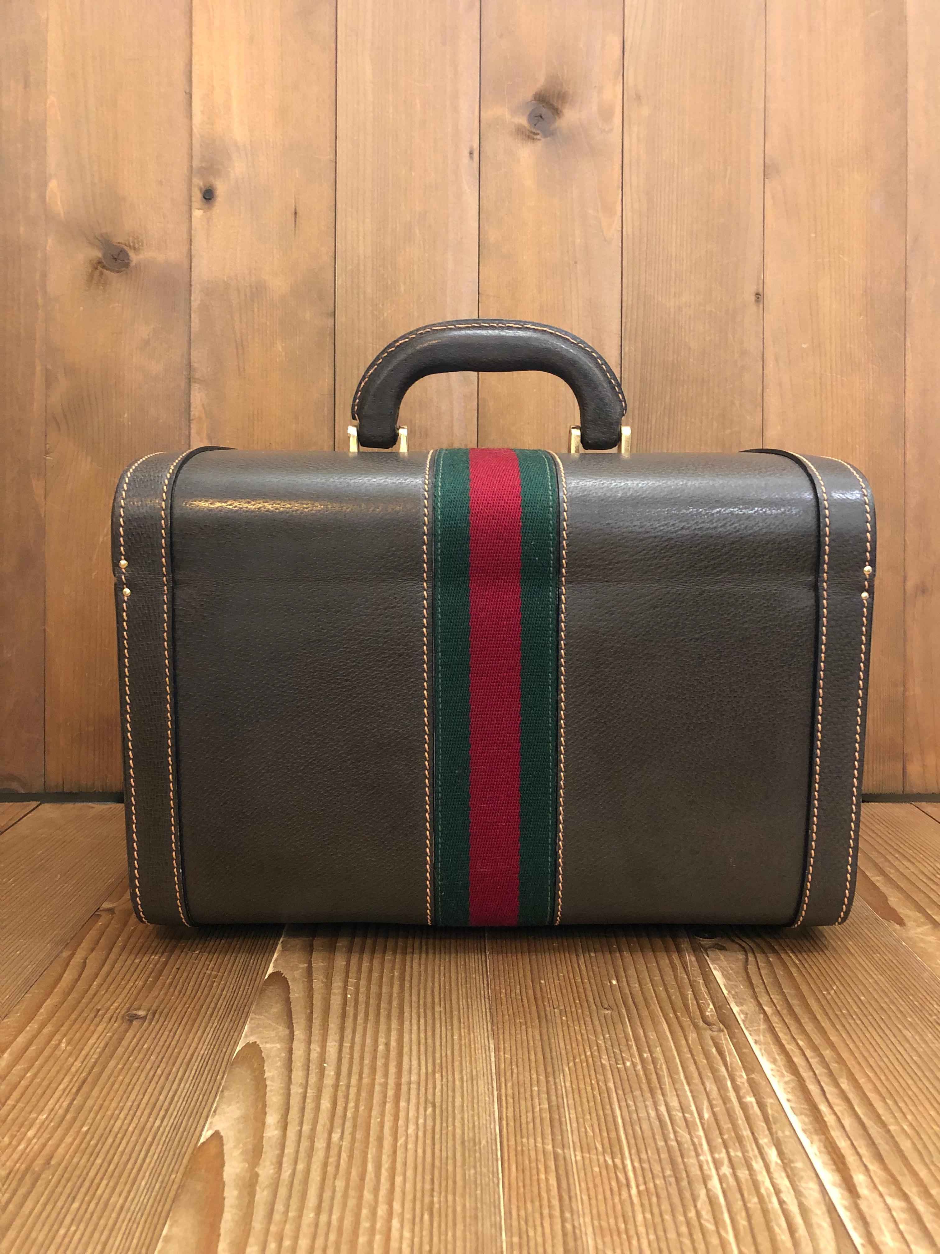 This 1970s vintage GUCCI Web Vanity trunk case is crafted of pigskin leather in brown decorated with Gucci’s iconic Web band in green and red. This trunk features a sturdy leather handle and two combination locks. Front double-locks closure opens to