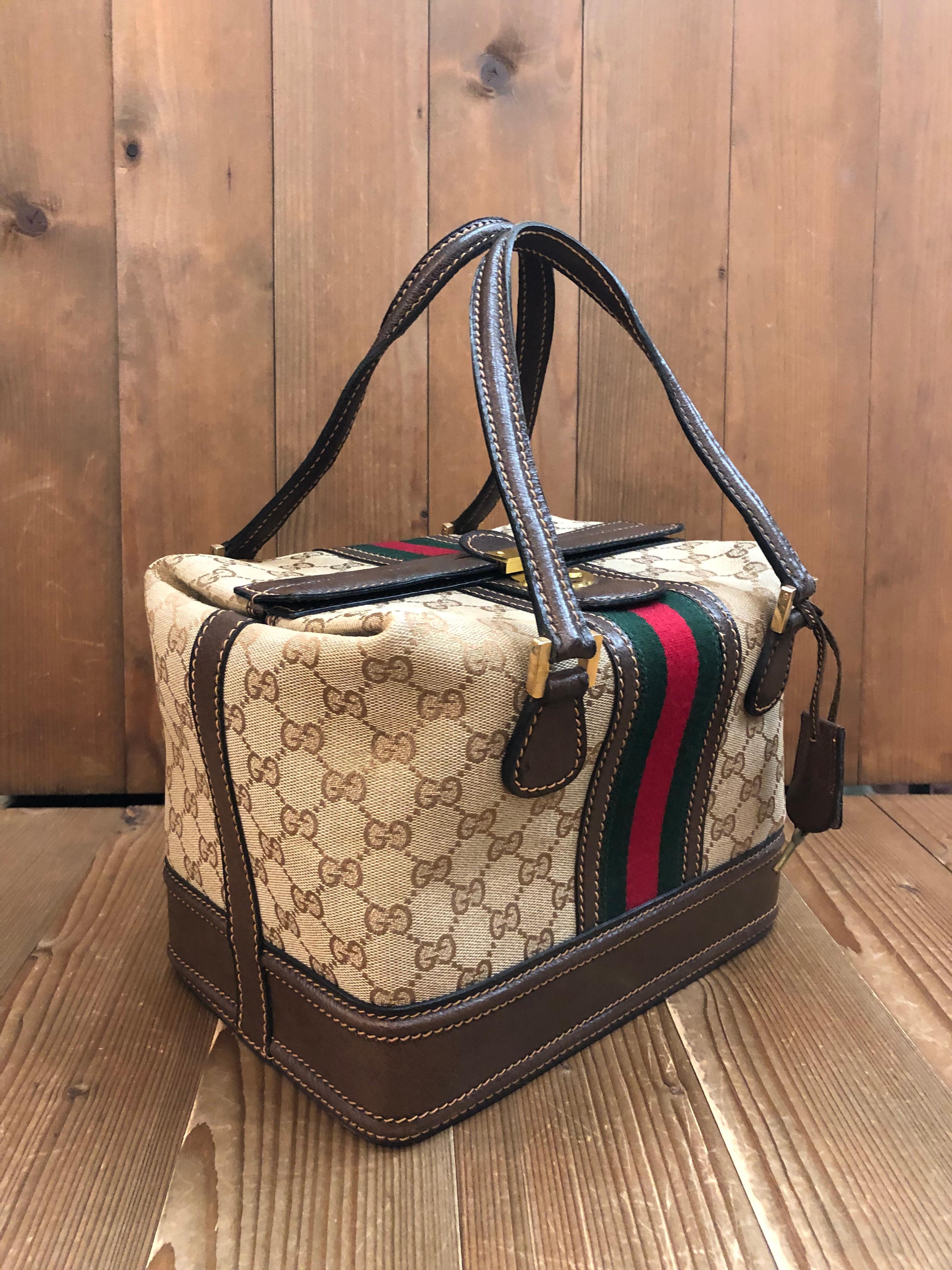 This small vintage GUCCI Web vanity trunk bag is crafted of brown GG monogram jacquard and pigskin leather in dark brown decorated with Gucci’s iconic red/green stripe. Top push lock opens to a laminated interior in beige featuring a leather strap
