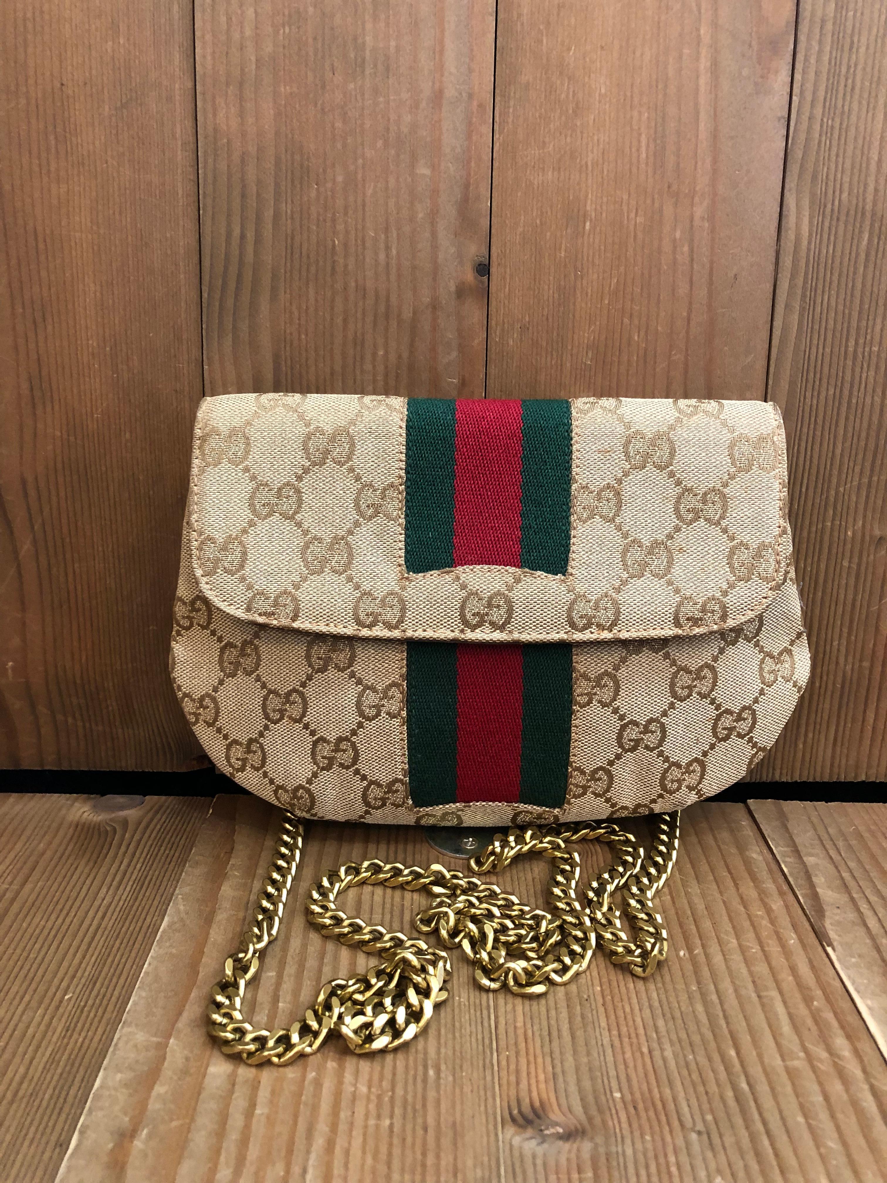 This vintage GUCCI pouch bag is crafted of GG monogram jacquard in brown featuring a green/red stripe. Front flap snap closure open to a nubuck leather interior. Made in Italy. Measures 7 x 6 x 1 inches. This pouch has been modified by adding third