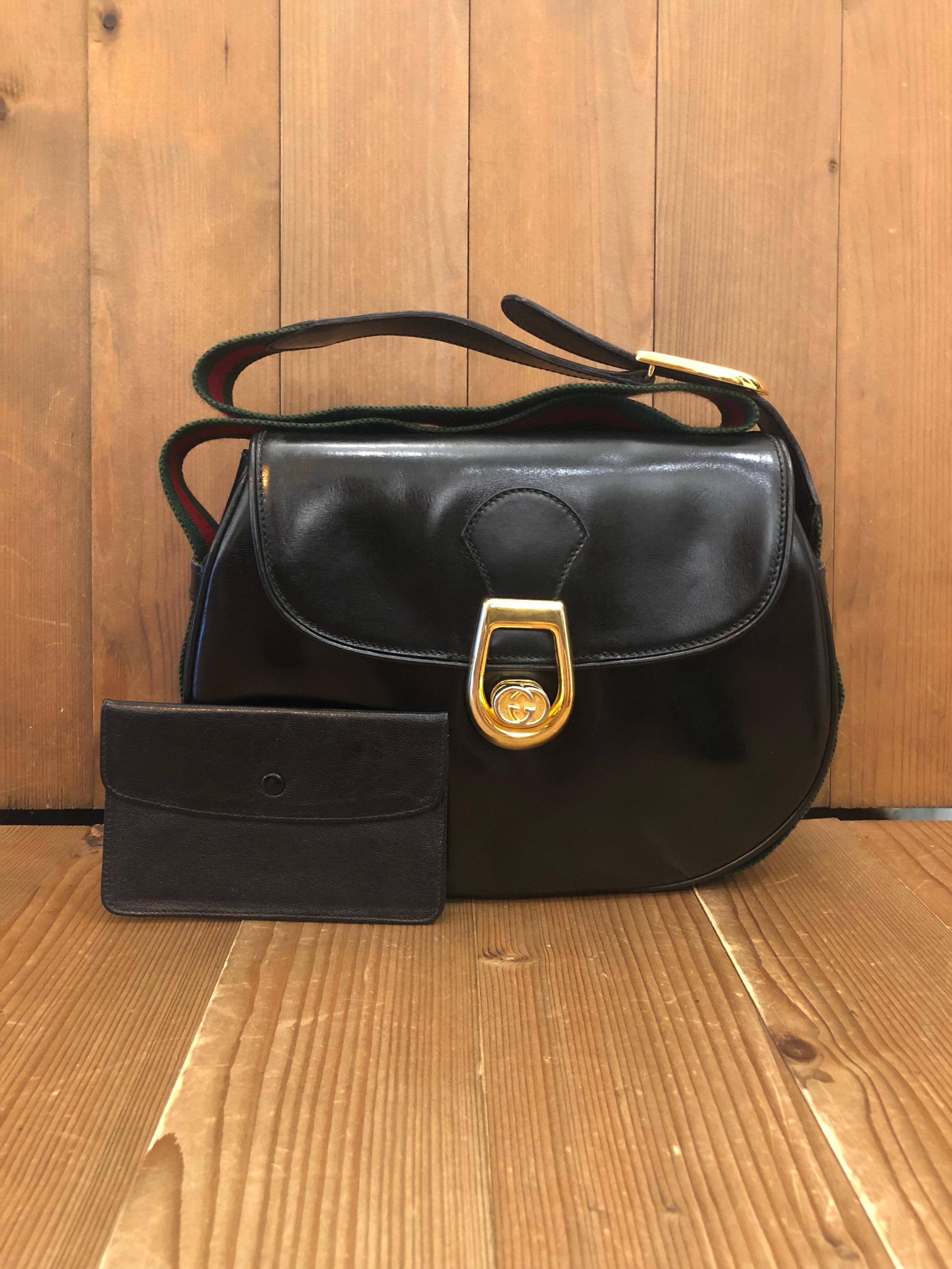 This vintage Gucci shoulder bag is crafted of smooth calf leather in black featuring an adjustable shoulder strap in Gucci’s iconic red/green web band around the main body. Front flap turnlock closure opens to a black leather interior with zippered