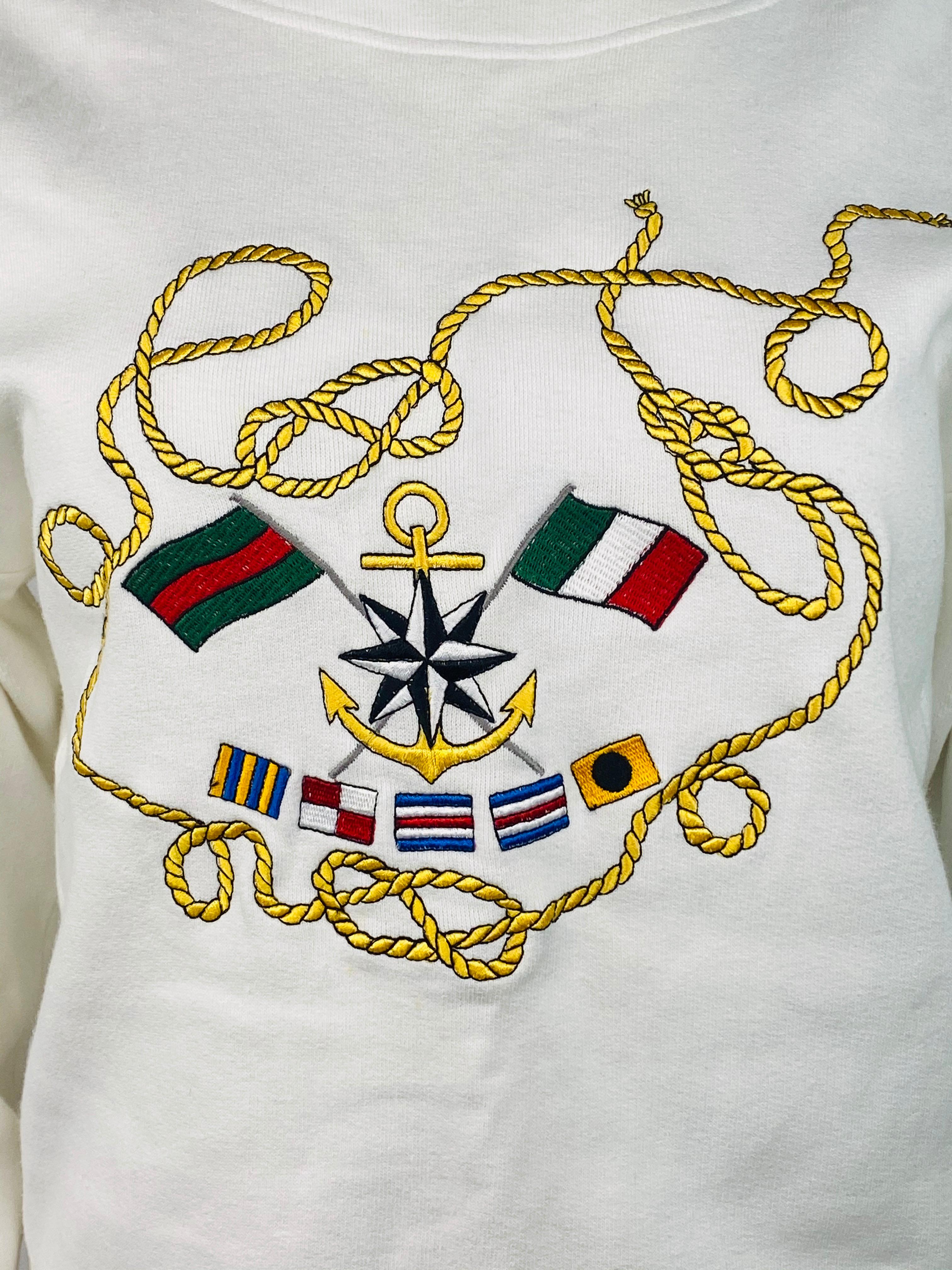 Product details:
Size Small.
Featuring white cotton sweatshirt with anchor, flags and sailing rope embroidery on the front, crew neck and three gold tone double G buttons.
Made in Italy.