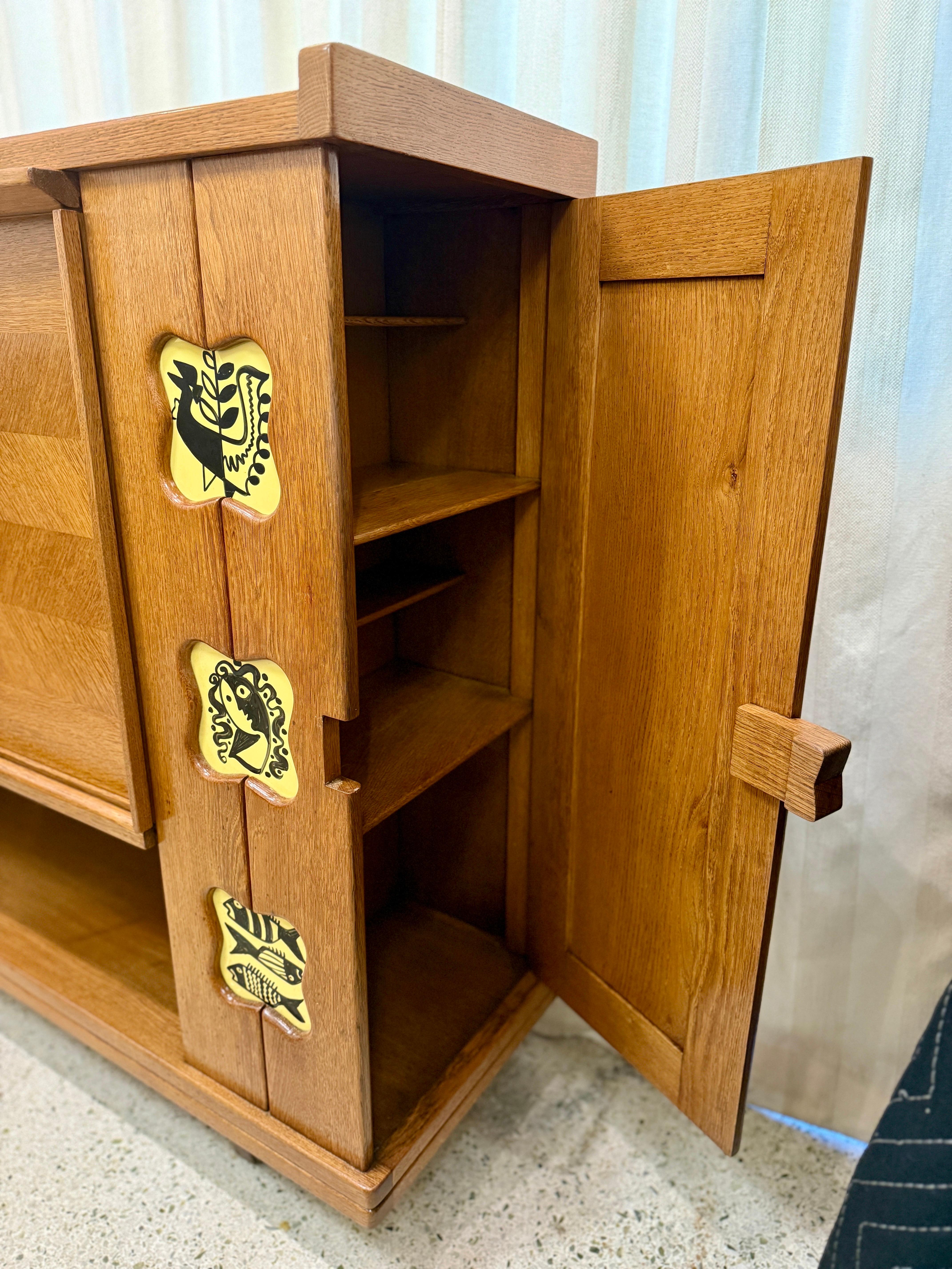 Guillerme et Chambron for Votre Maison, high sideboard, solid oak, France, 1960s.  This characteristic cabinet in solid oak is designed by the French designer duo Jacques Chambron (1914-2001) and Robert Guillerme, (1913-1990). It features two
