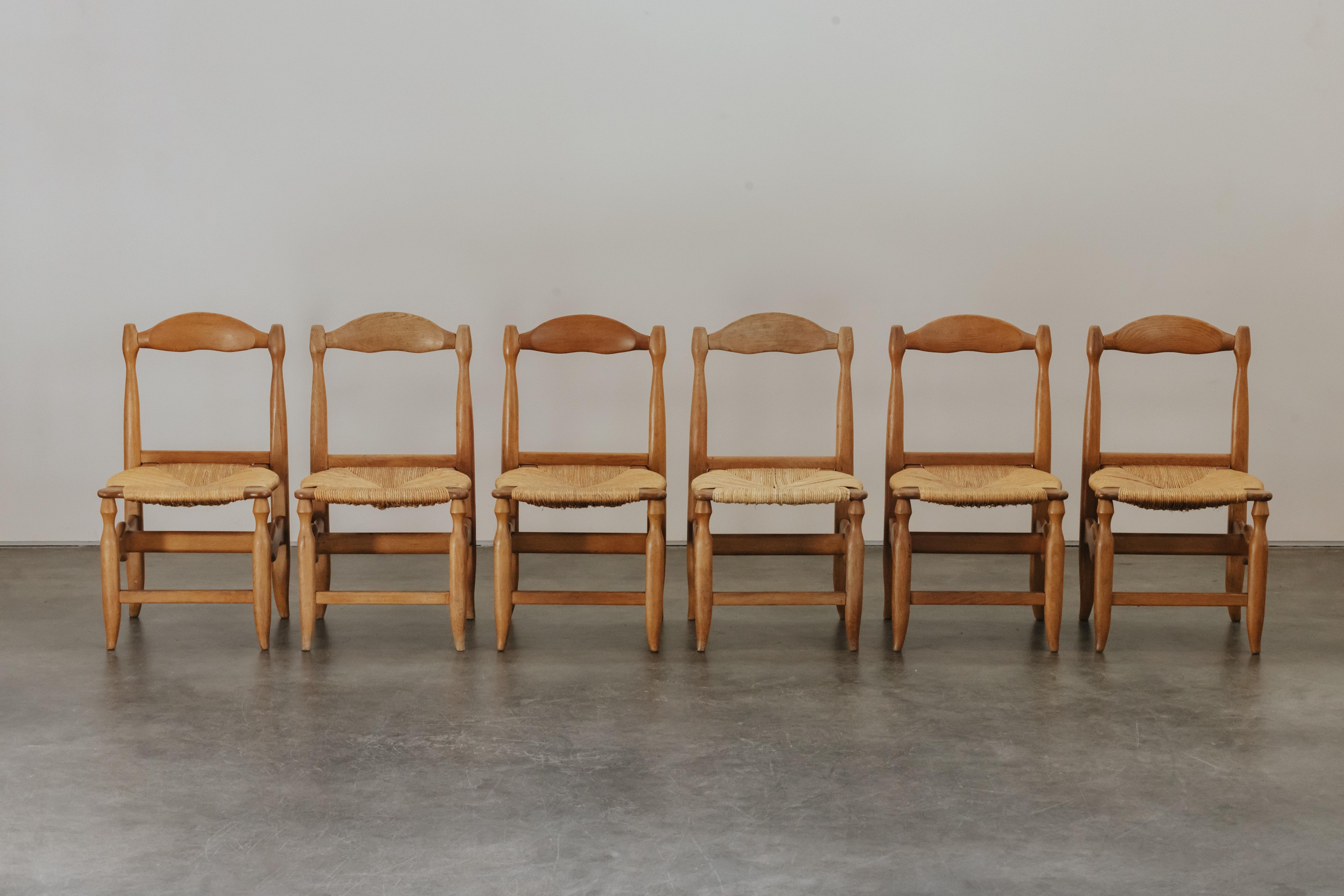 Vintage Guillerme et Chambron Dining Chairs in Oak, From France, 1970.  Solid oak construction with straw seats.  Nice patina and use.