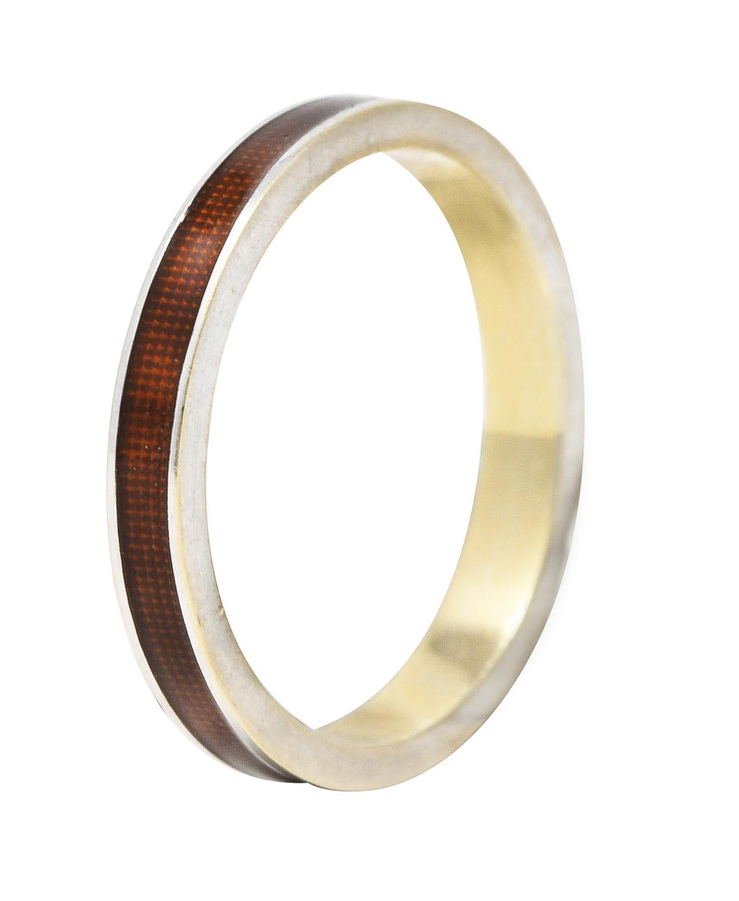 Band ring features a recessed guilloche enamel channel fully around. Transparent medium brown in color - glossed over engraved grid pattern. With high polished white gold surround. Tested as 18 karat gold. Attributed to Hidalgo. Circa: 1990's. Ring