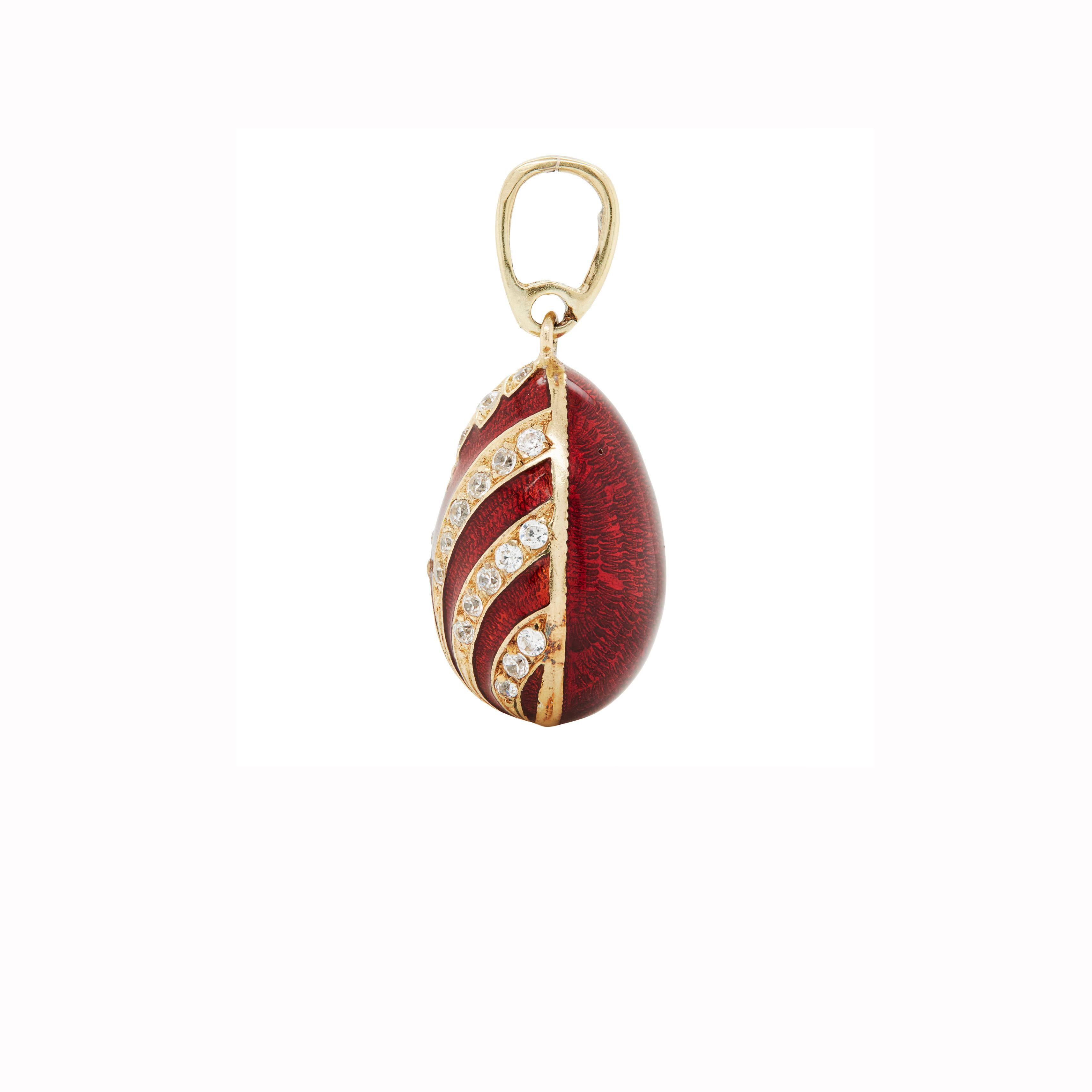 This exquisite 14 carat yellow gold enamel egg charm/pendant is a little treasure full of vintage charm. 

Intricately designed, this charm features a rich, deep red Guilloché enamel finish, beautifully contrasted by delicate gold accents and