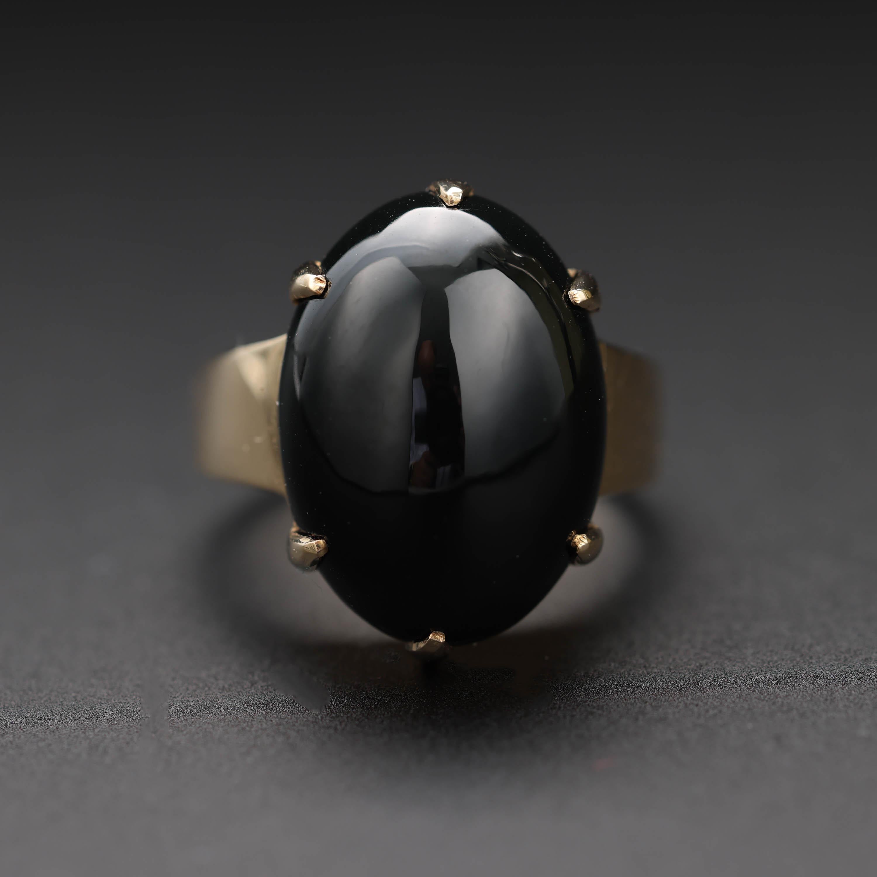This is an iconic black jade ring from Gump's San Francisco featuring an oval cabochon of natural and untreated black jade. This style of jade ring has proven incredibly elusive; I almost never encounter other rings like this one. The piano-black