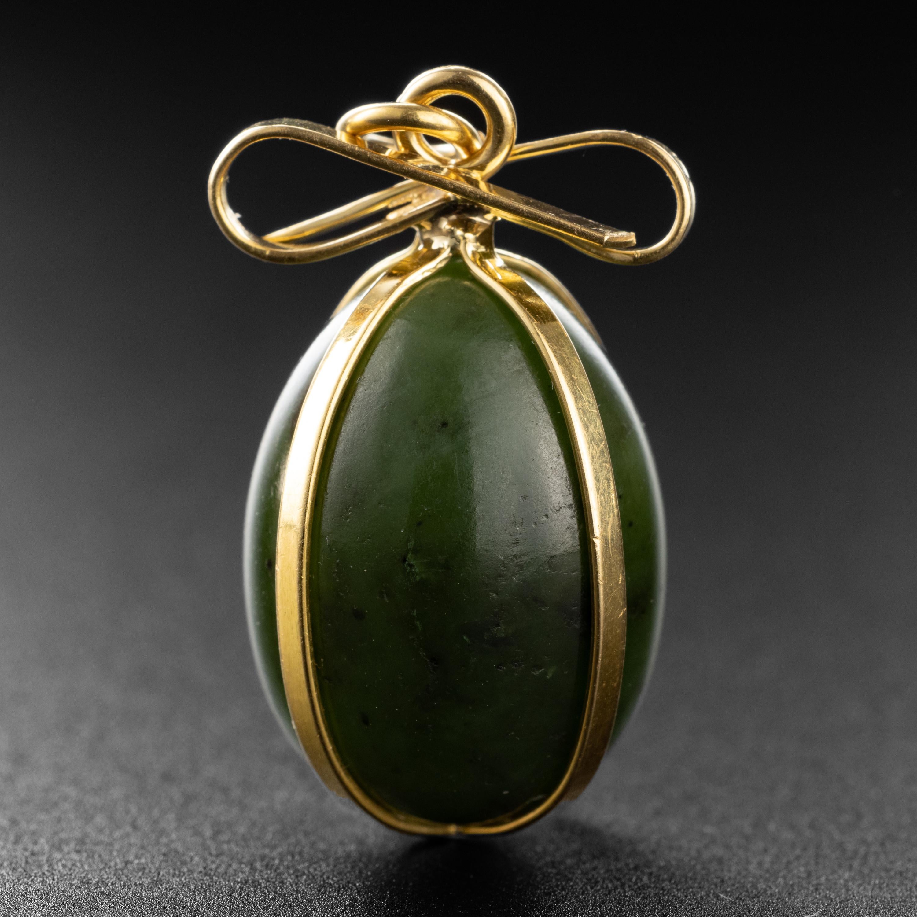 What a treasure for the Gump's collector and jade lover! This 1970's jewel from the iconic San Francisco retailer, Gump's, features a hand-carved deep forest green nephrite jade egg wrapped securely in ribbons of buttery 18k yellow gold and tied