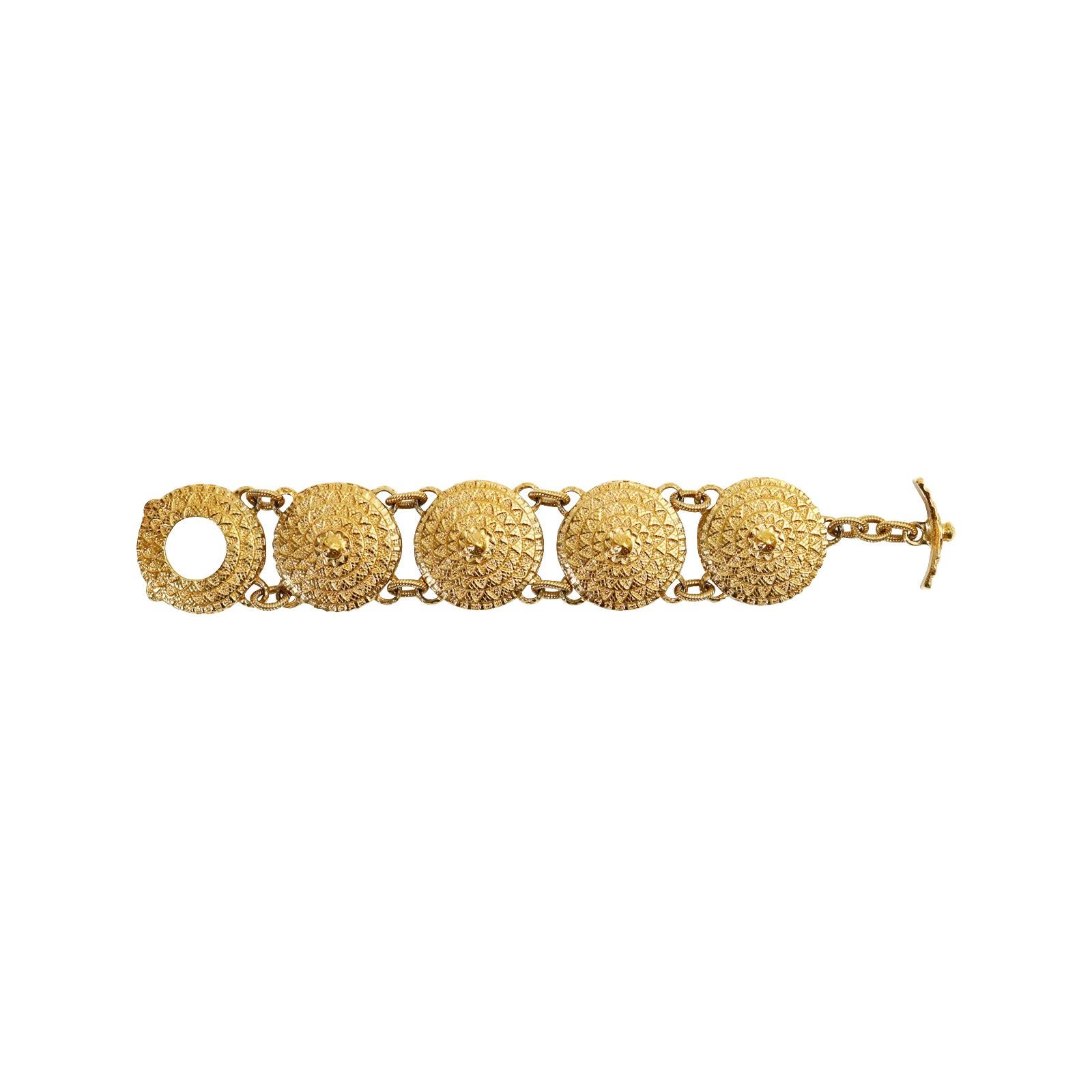 Vintage Guy Laroche Gold Shields Link Bracelet Circa 1980s. There are four shields or at least that is what I call them and then an open one where the toggle closes. A very classic edgy bracelet. A very well known celebrity has the matching earrings