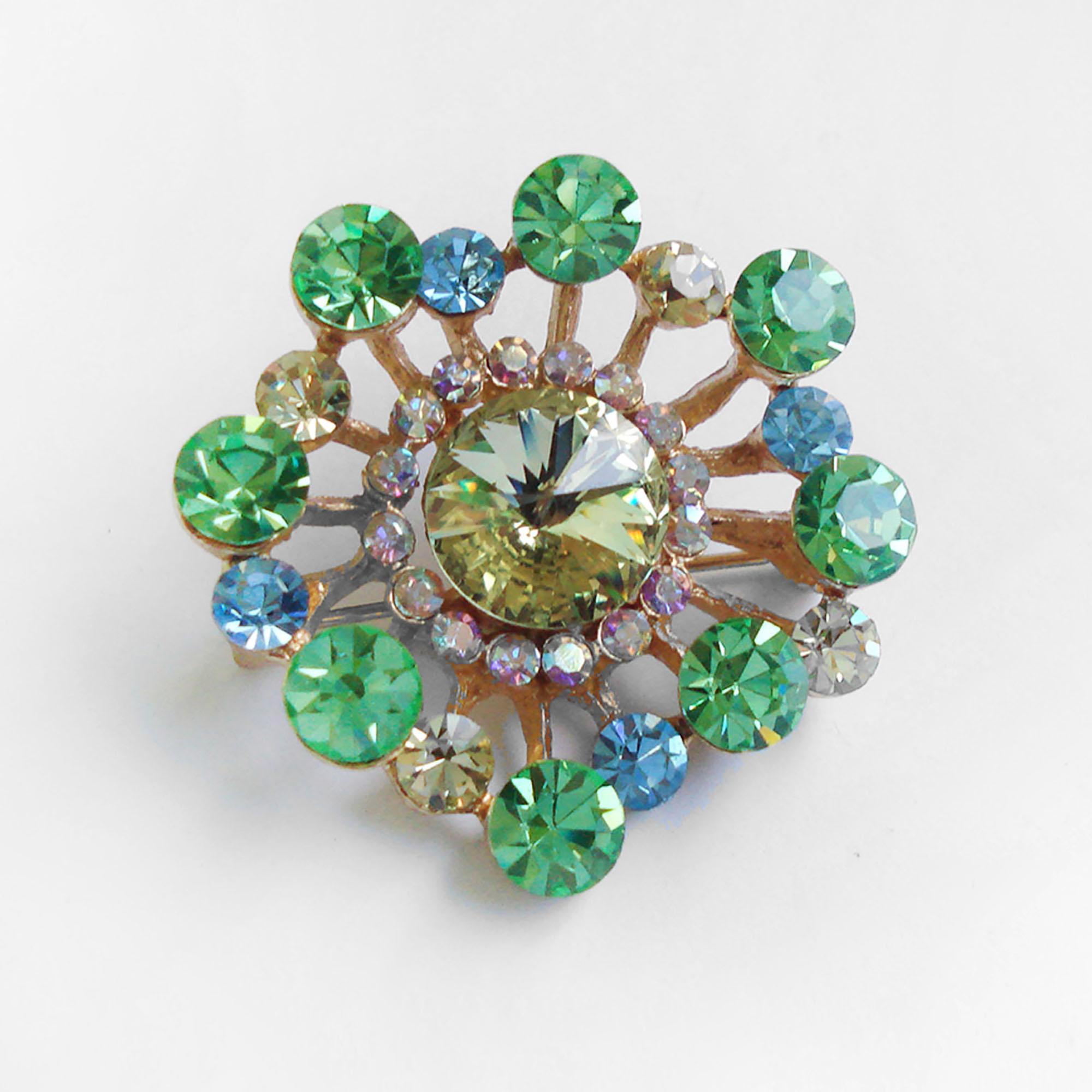 Vintage Guy Laroche Brooch, made of green, blue and clear crystal inserted in a golden structure. Marked on the reverse. 
Condition: Excellent condition.
Materials and Techniques: gilt metal, colored Rhinestones
Marks: Guy Laroche, Paris
Date of