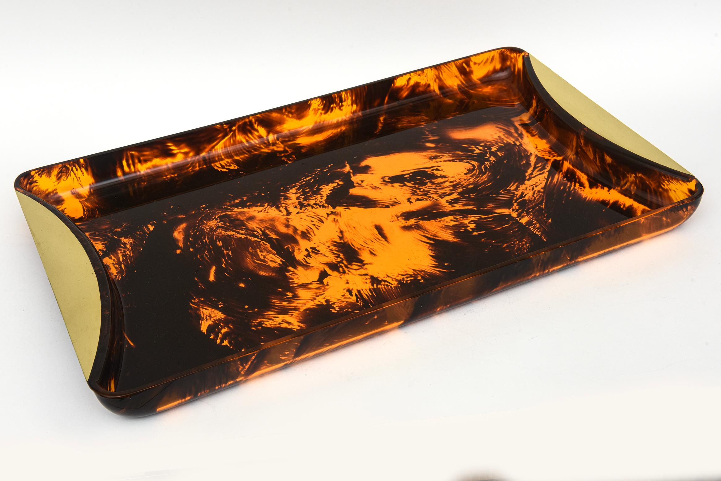 This vintage Rede Guzzini Italian faux tortoise lucite tray with brass handles has been professionally polished and makes great barware and serving needs. The tortoise swirled affect of the lucite gives dimension. It is a long rectangular tray for