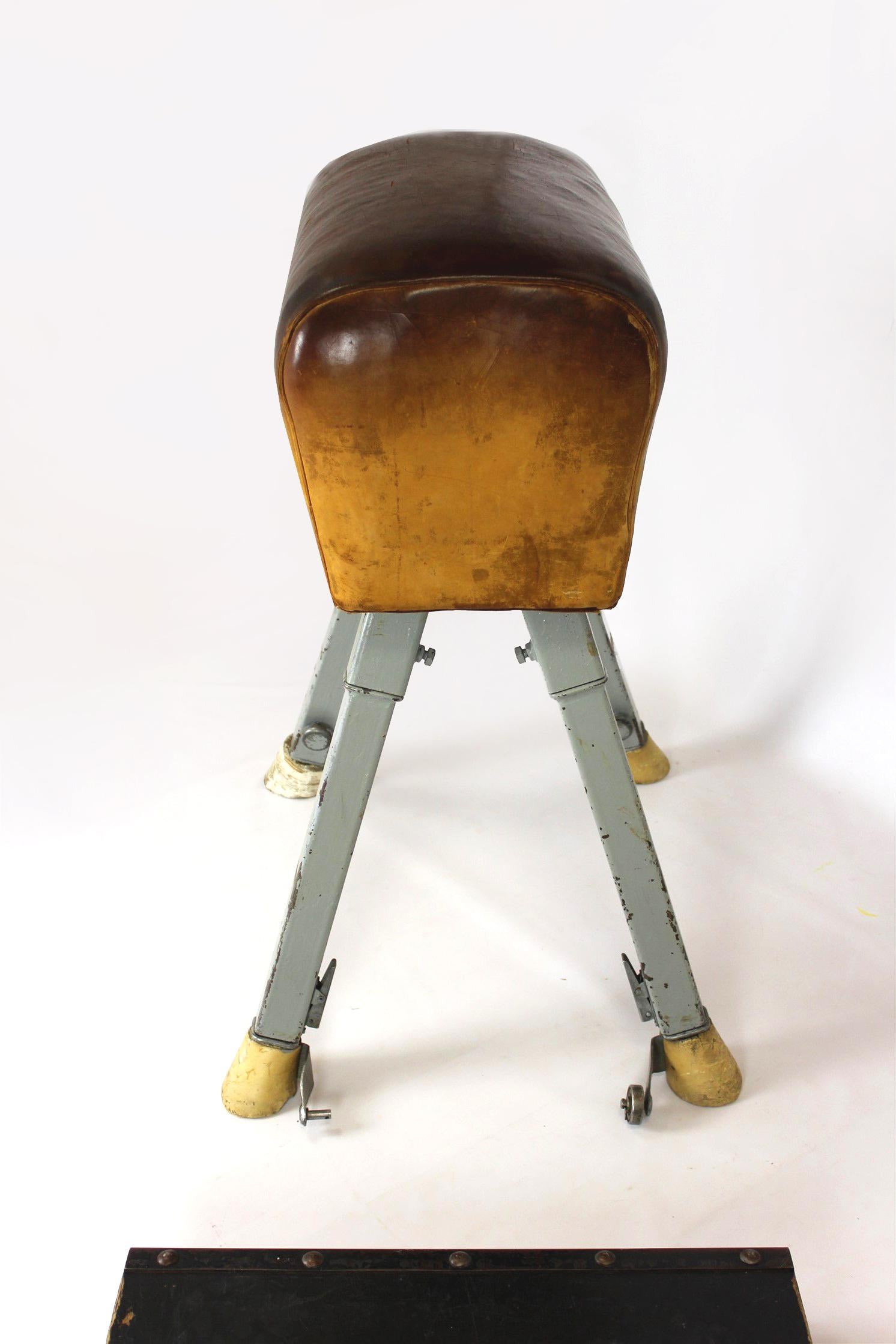 
This vintage leather gymnastics horse was manufactured in Poland in the 1960s. The set also includes a springboard. Please send us a message with your postcode to provide an accurate shipping cost.