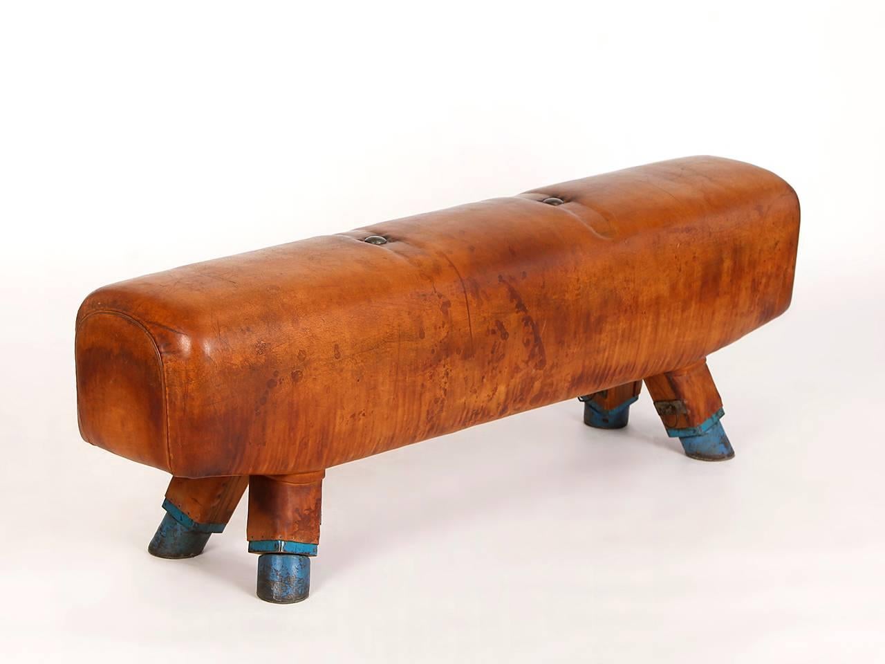 Pommel horse from former Czechoslovakia. The legs were cut to a height of 54cm. The handles can be removed for comfortable seating. The wooden handles were restored. The thick leather has been cleaned and the patina was retained. Very good vintage
