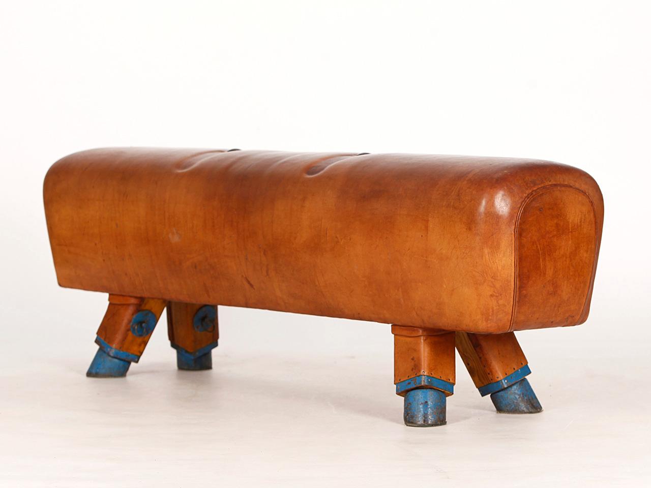 Pommel horse from former Czechoslovakia. The legs were cut to a height of 53cm. The thick leather has been cleaned and the patina was retained. Very good vintage condition.
