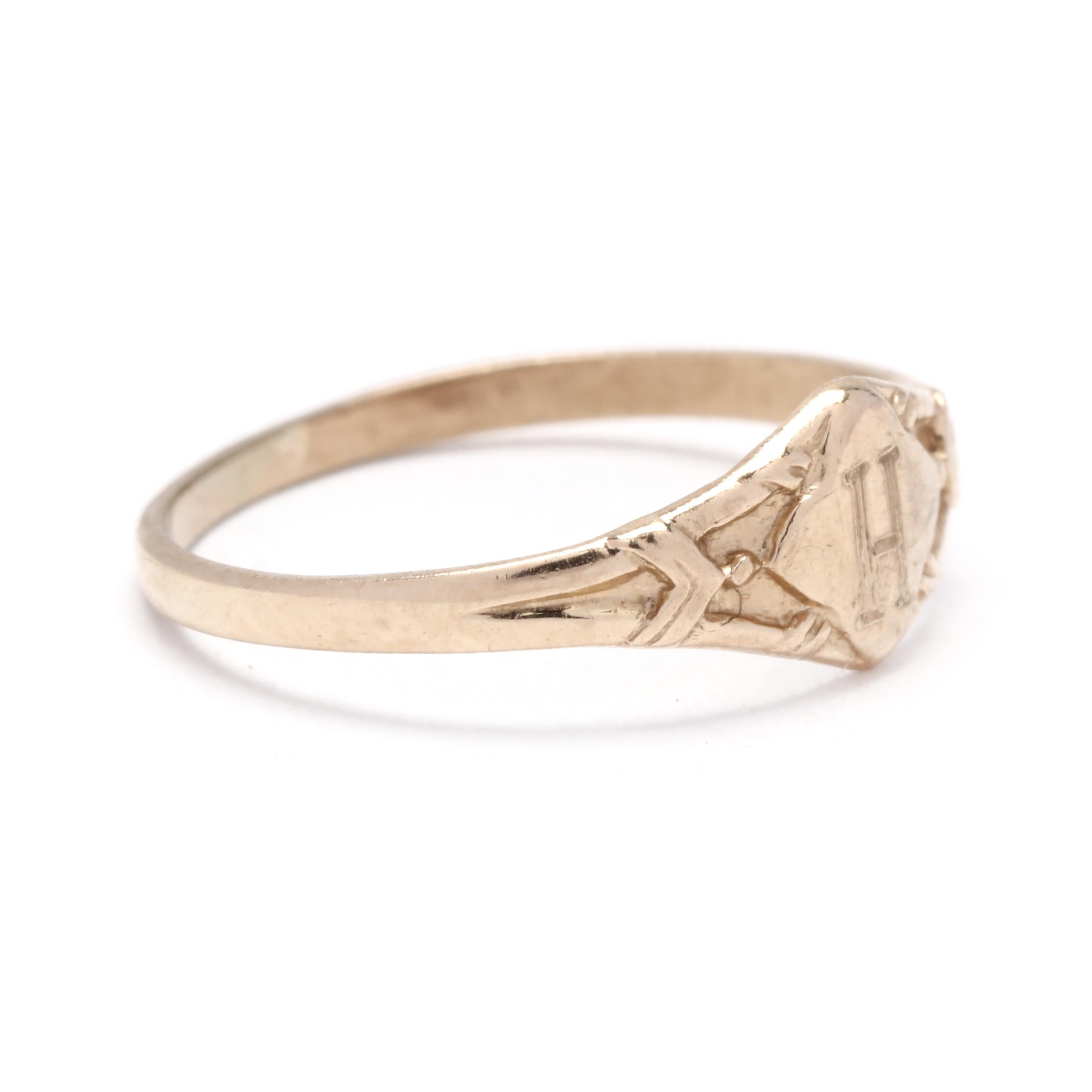 A vintage 10 karat yellow gold H initial baby signet ring. This initial midi signet ring features a tapered design with a  central clover motif engraved with an H and applied gold detailing to the band.

Ring Size 2

Rise Off Of Finger: 1 mm

Width: