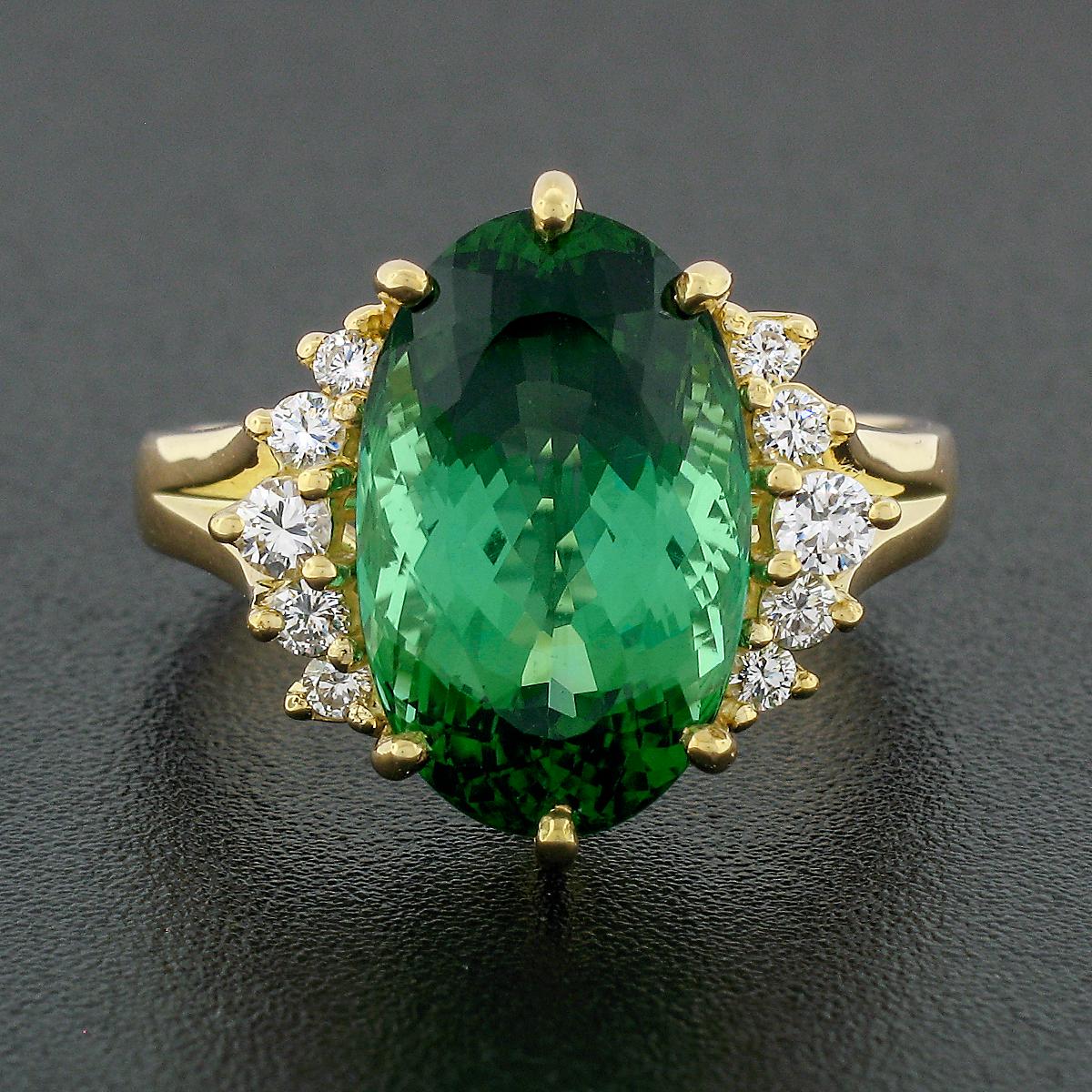 This stunning, vintage, H.Stern ring is crafted in solid 18k yellow gold and features a very fine and HIGH QUALITY tourmaline stone neatly set at center with round brilliant diamond accents at the sides. The large tourmaline displays the most