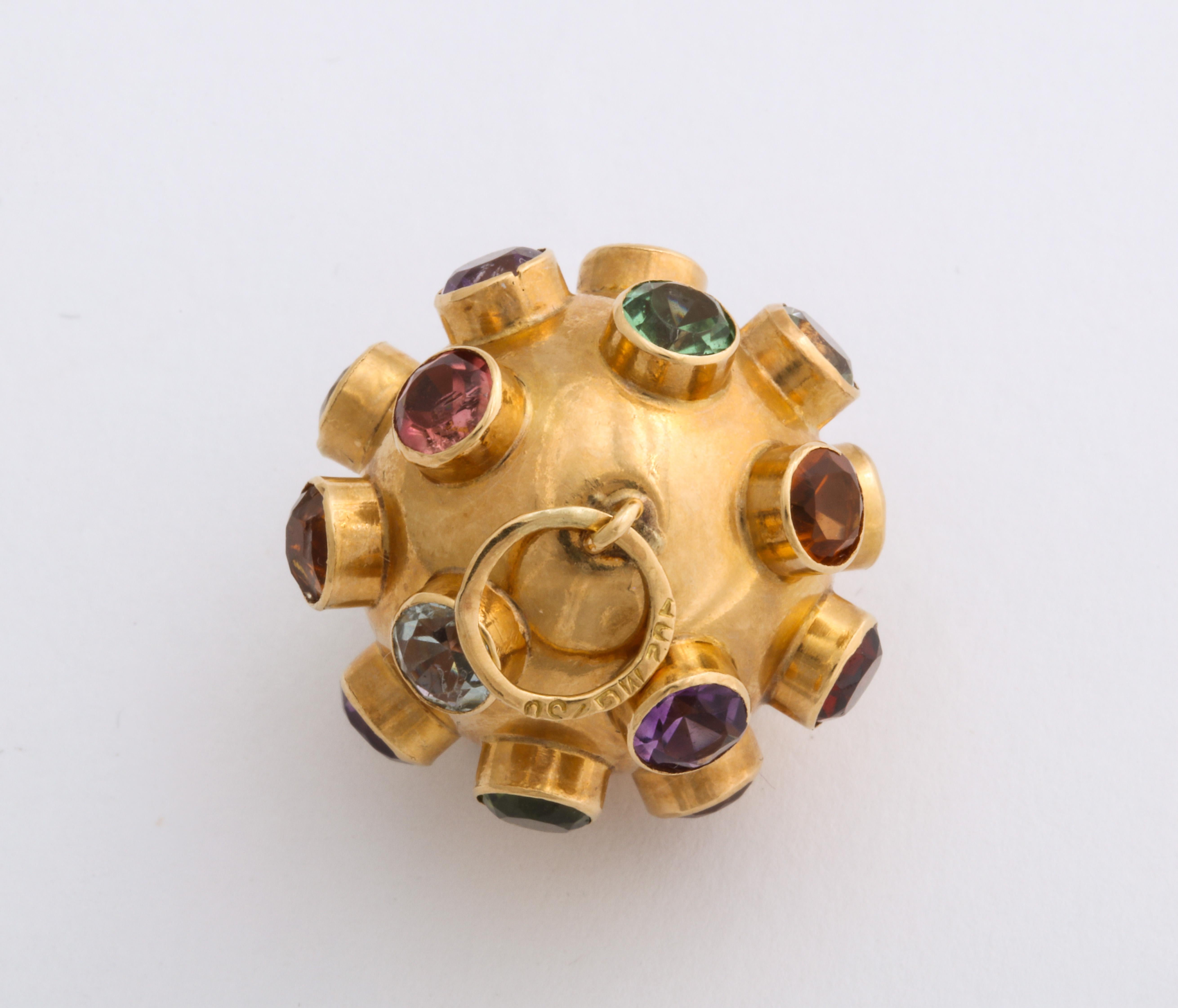 In 14 Kt, this pendant or charm, a gem studded ball, is set with colors true to their calling, garnet, aquamarine, citrine, amethyst, sapphire and green tourmaline. The stones are deeply set, each in their own collet. Sputnik, the first artificial